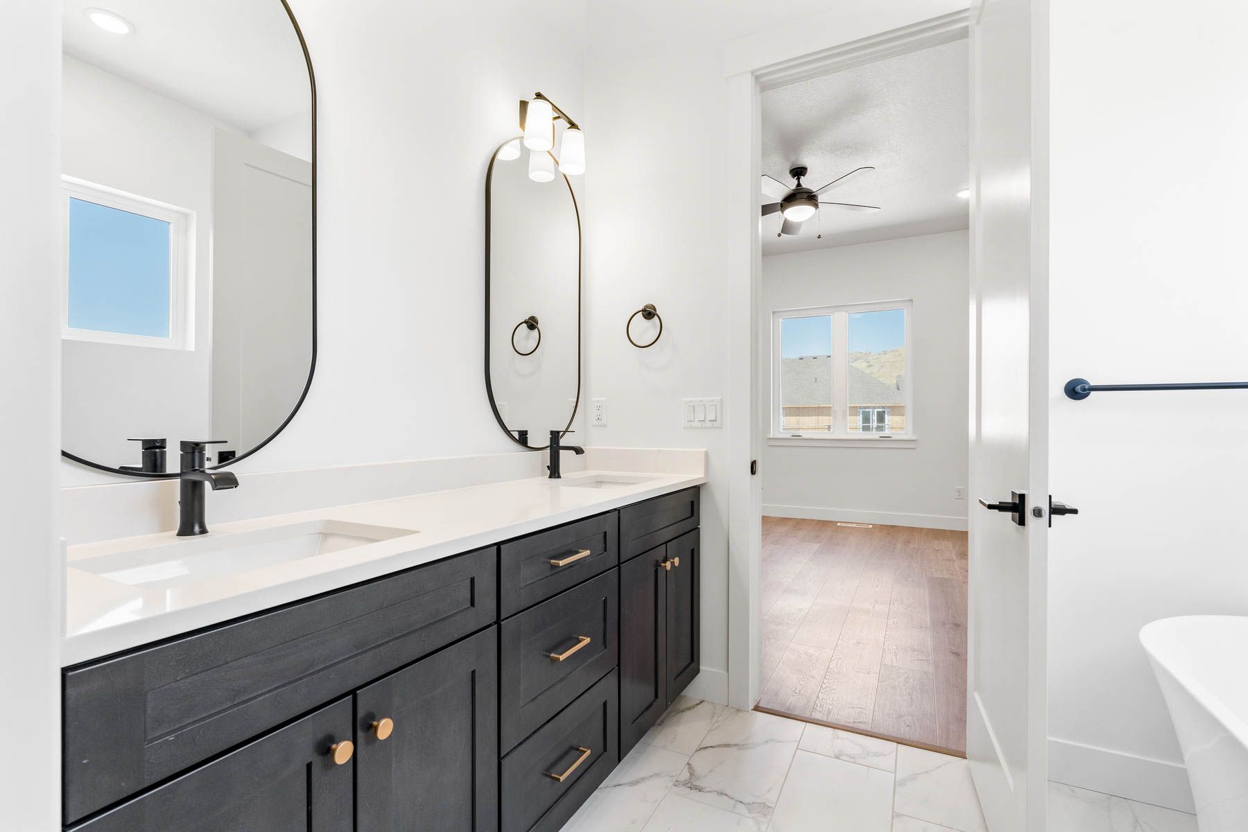 The master bathroom has a large vanity with dual sinks.