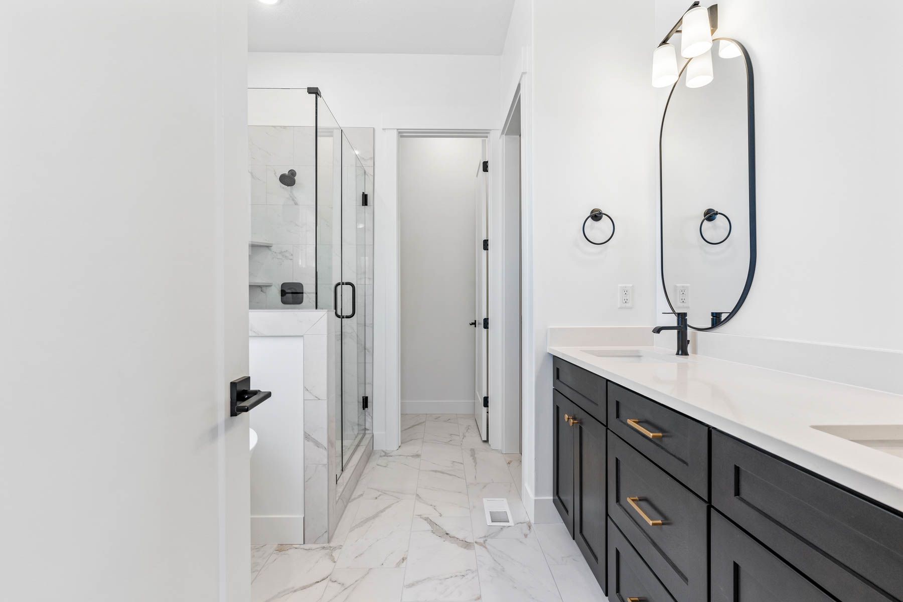 The master bathroom has a large vanity with dual sinks.
