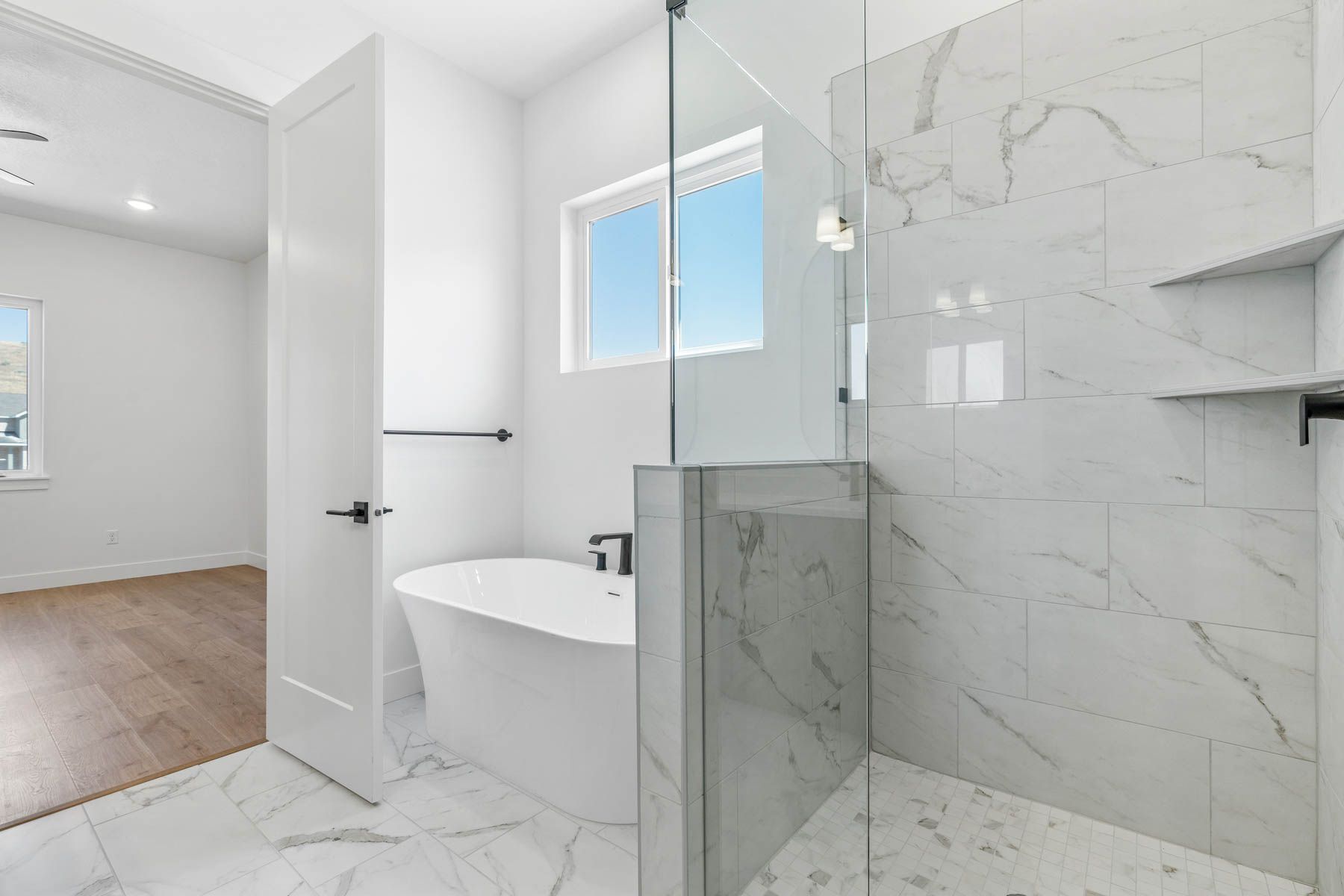 The master bathroom has a glass, walk-in shower and a large soaker tub. 