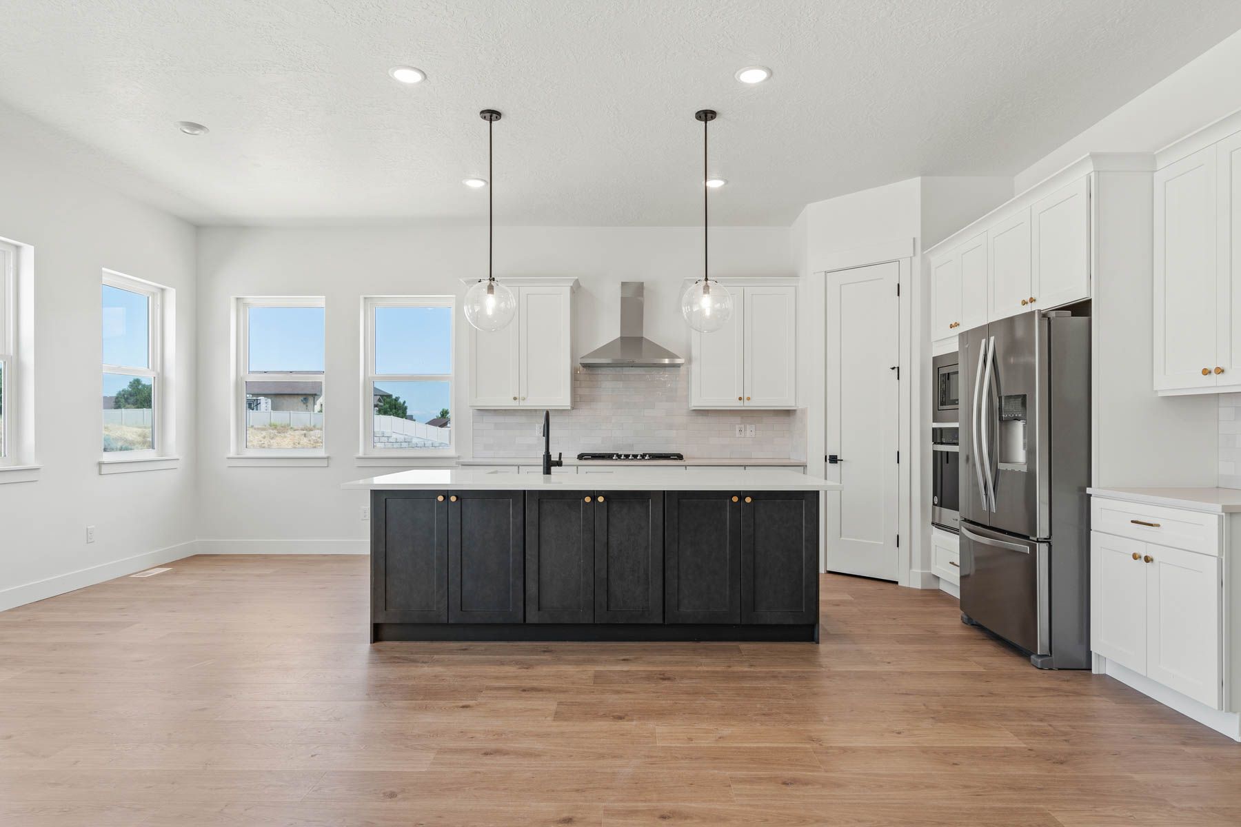 The kitchen has beautiful white wood cabinets, quartz countertops and energy-efficient appliances.