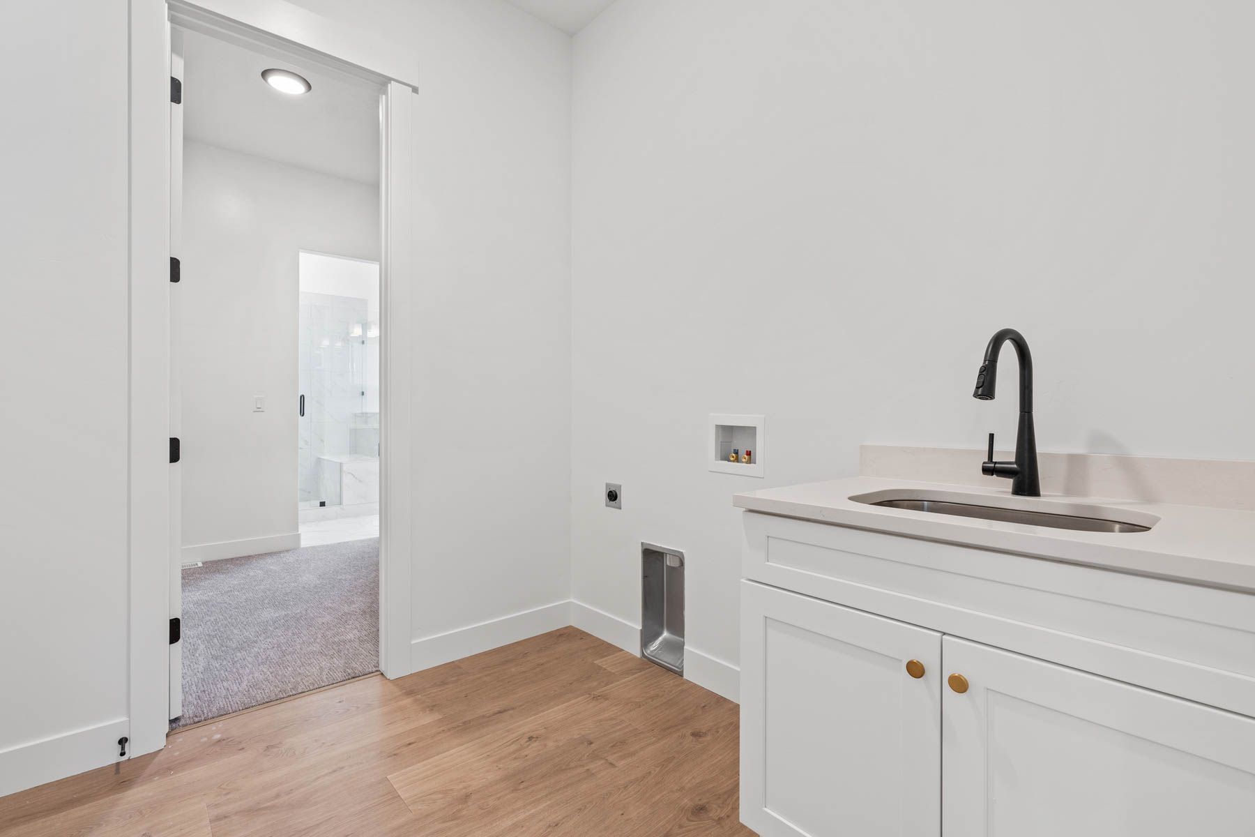 This home boasts a spacious laundry room feauturing a sink.