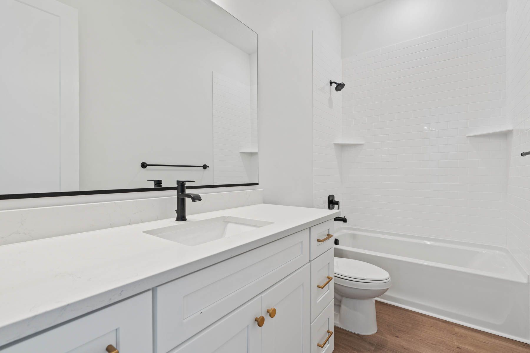 The secondary bathroom has a large vanity space.