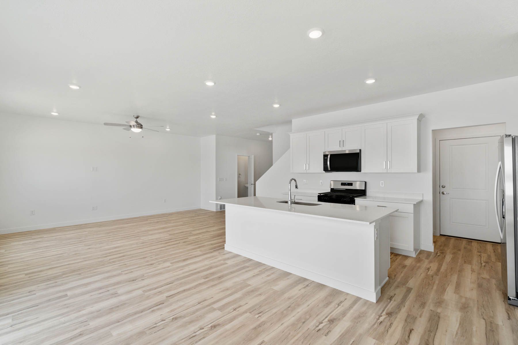 The kitchen has beautiful white wood cabinetry.