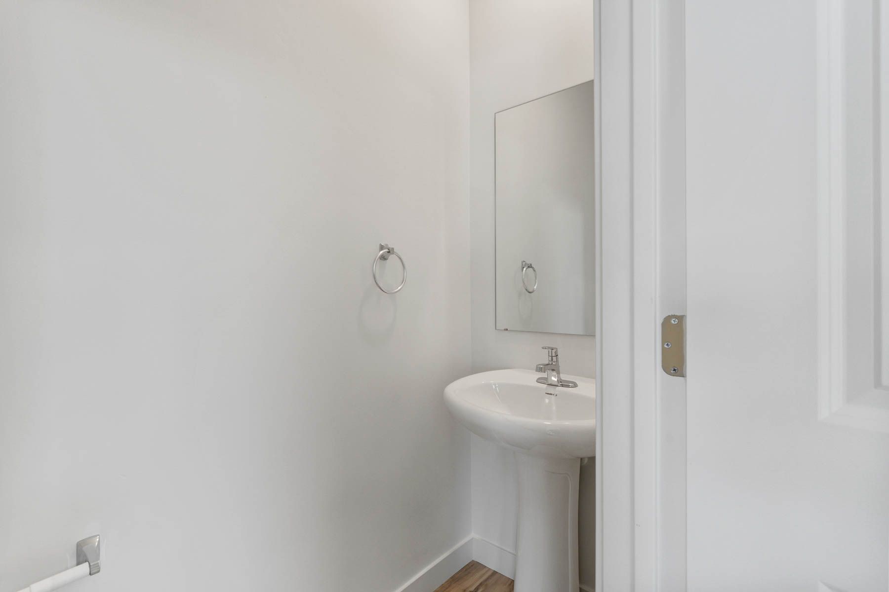 The half bathroom is located downstairs off of the open living spaces.
