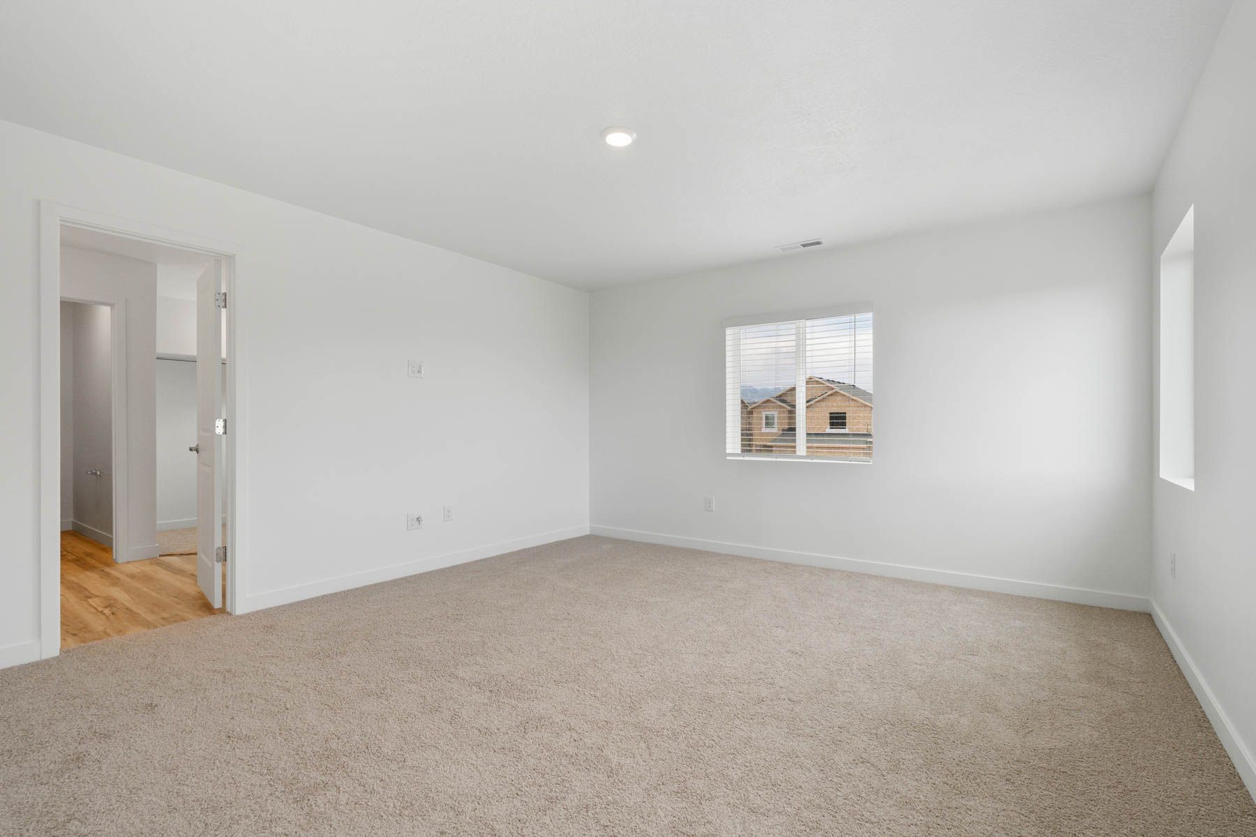 The master bedroom has a large window that lets in great, natural light. 