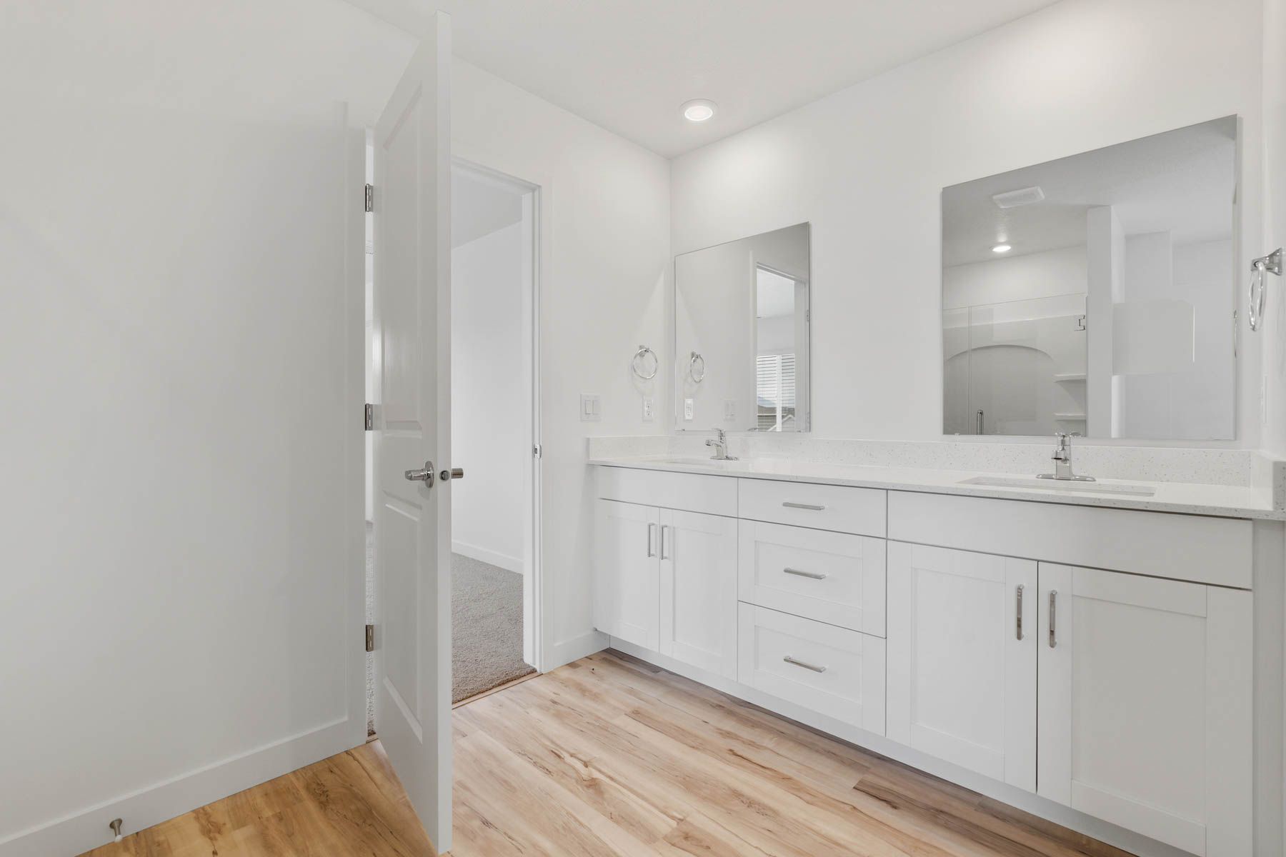 The master bathroom has a sprawling dual-sink vanity. 