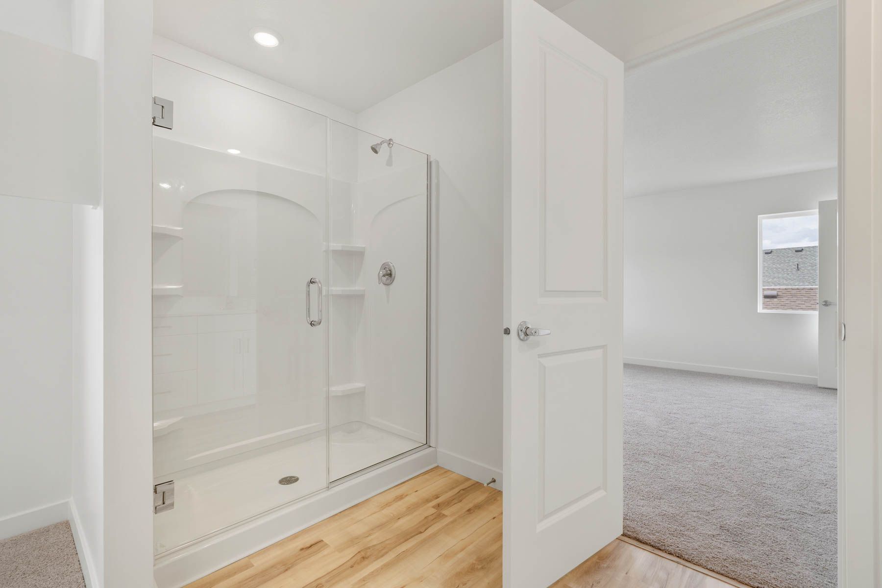 The master bathroom has a walk-in, glass shower.