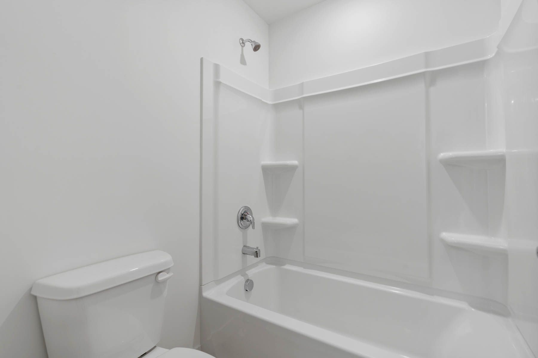 The secondary bathroom has a shower-tub combo.