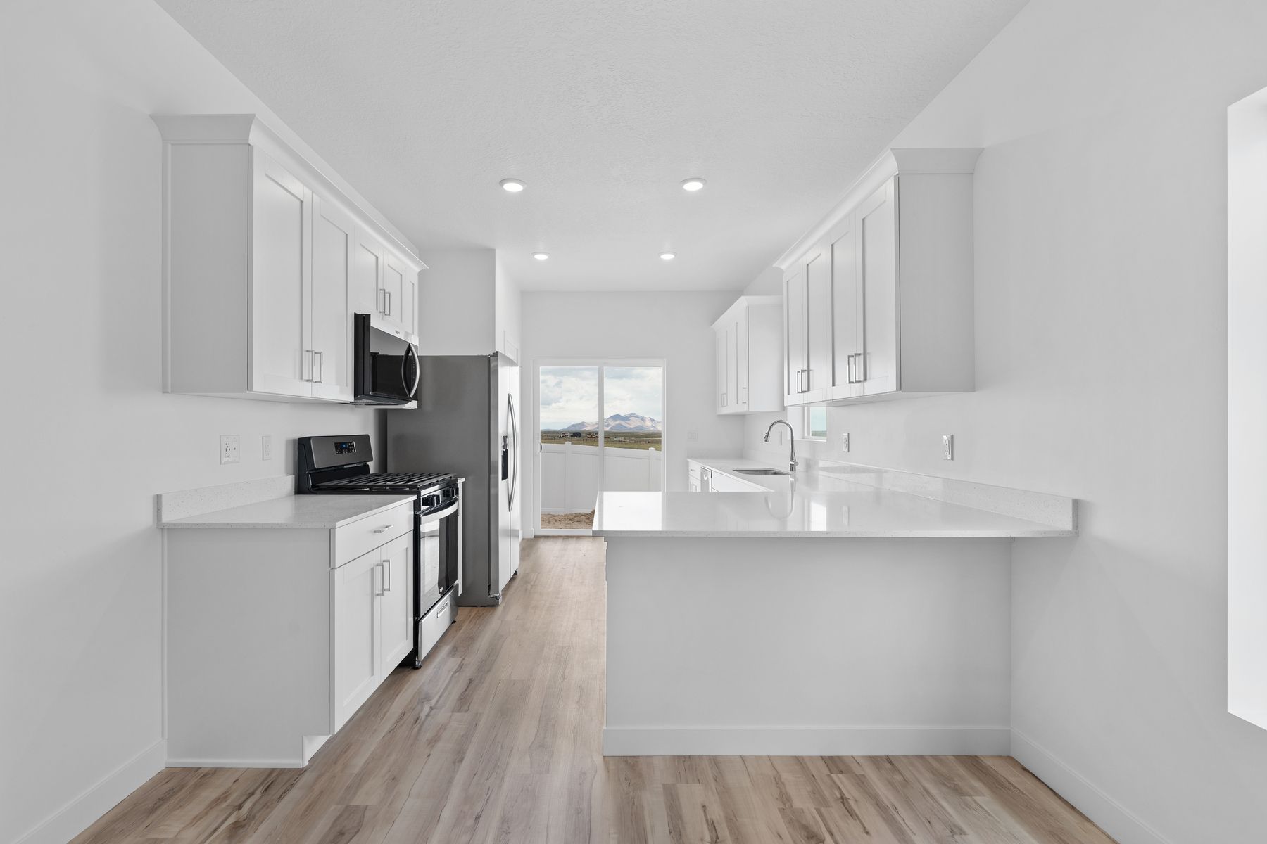 The kitchen has sprawling quartz countertops.