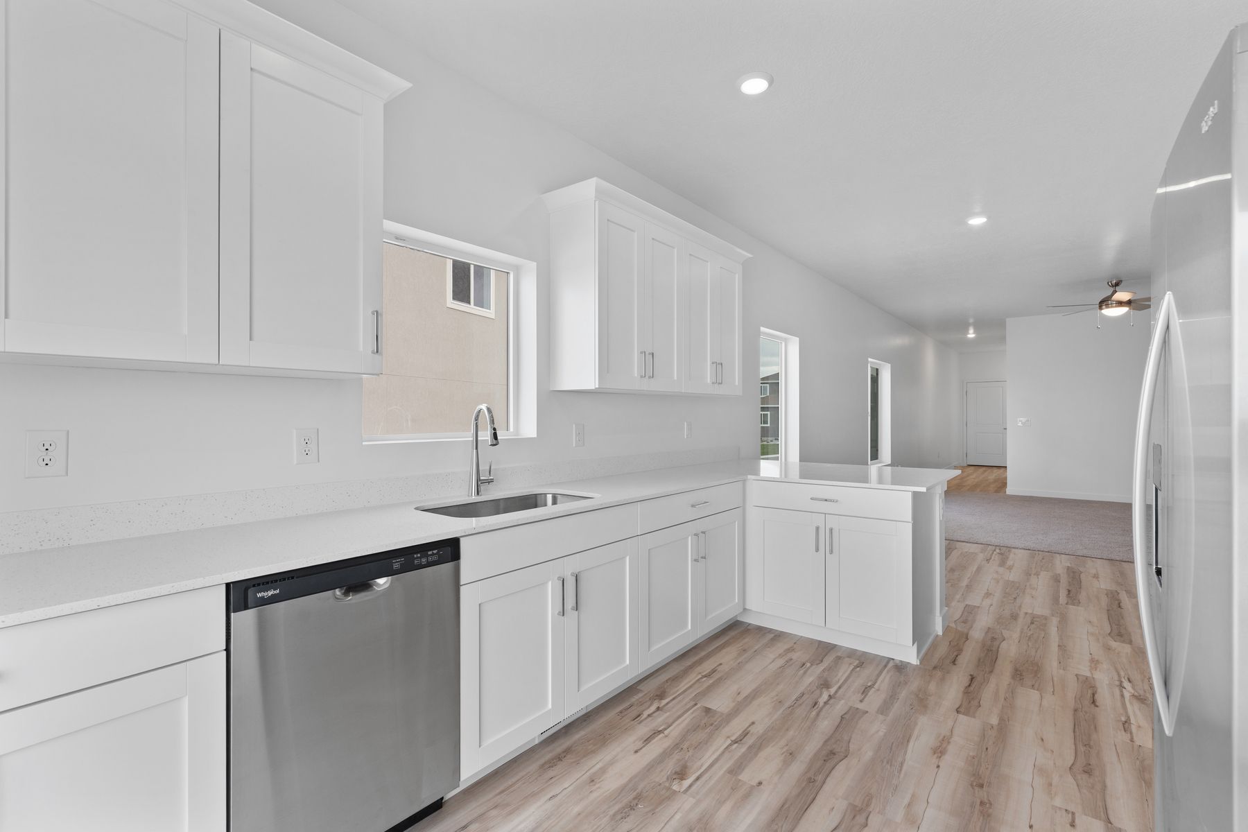 The kitchen has beautiful white wood cabinetry.