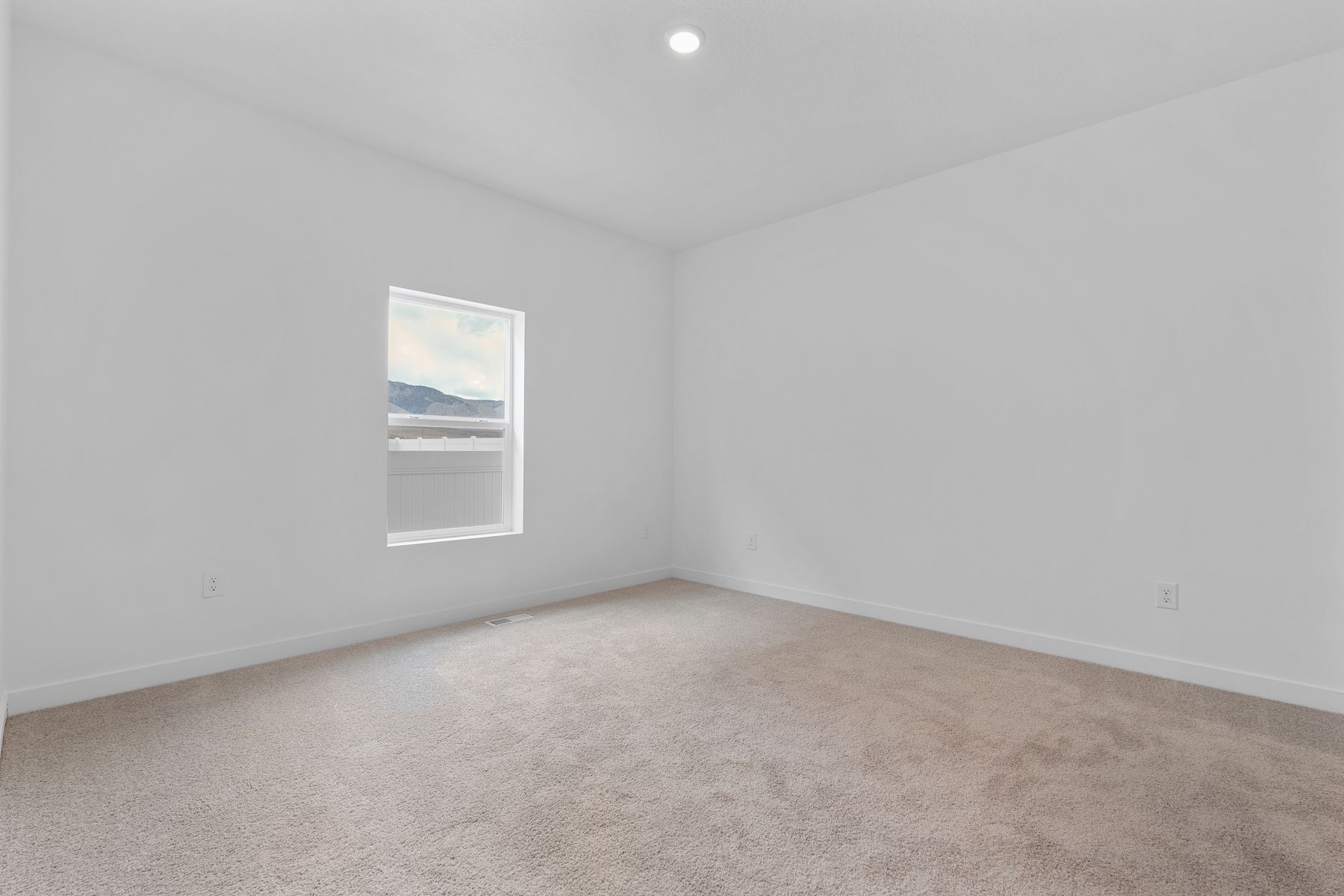 The master bedroom has a large window that lets in great, natural light. 