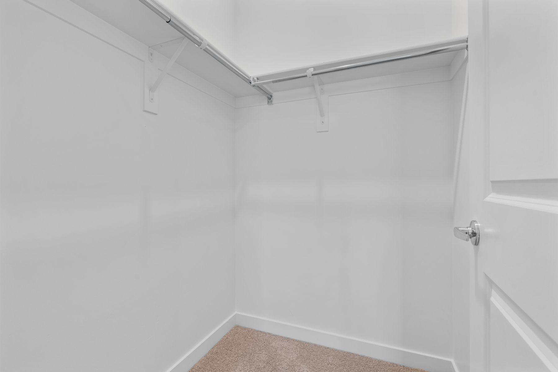 The walk-in closet has plenty of space for clothes, shoes and other personal belongings.