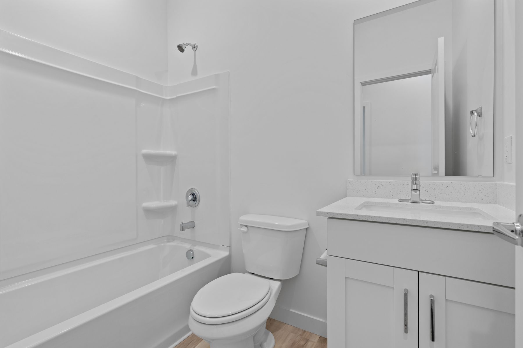 The secondary bathroom has a sprawling vanity and shower-tub combo.