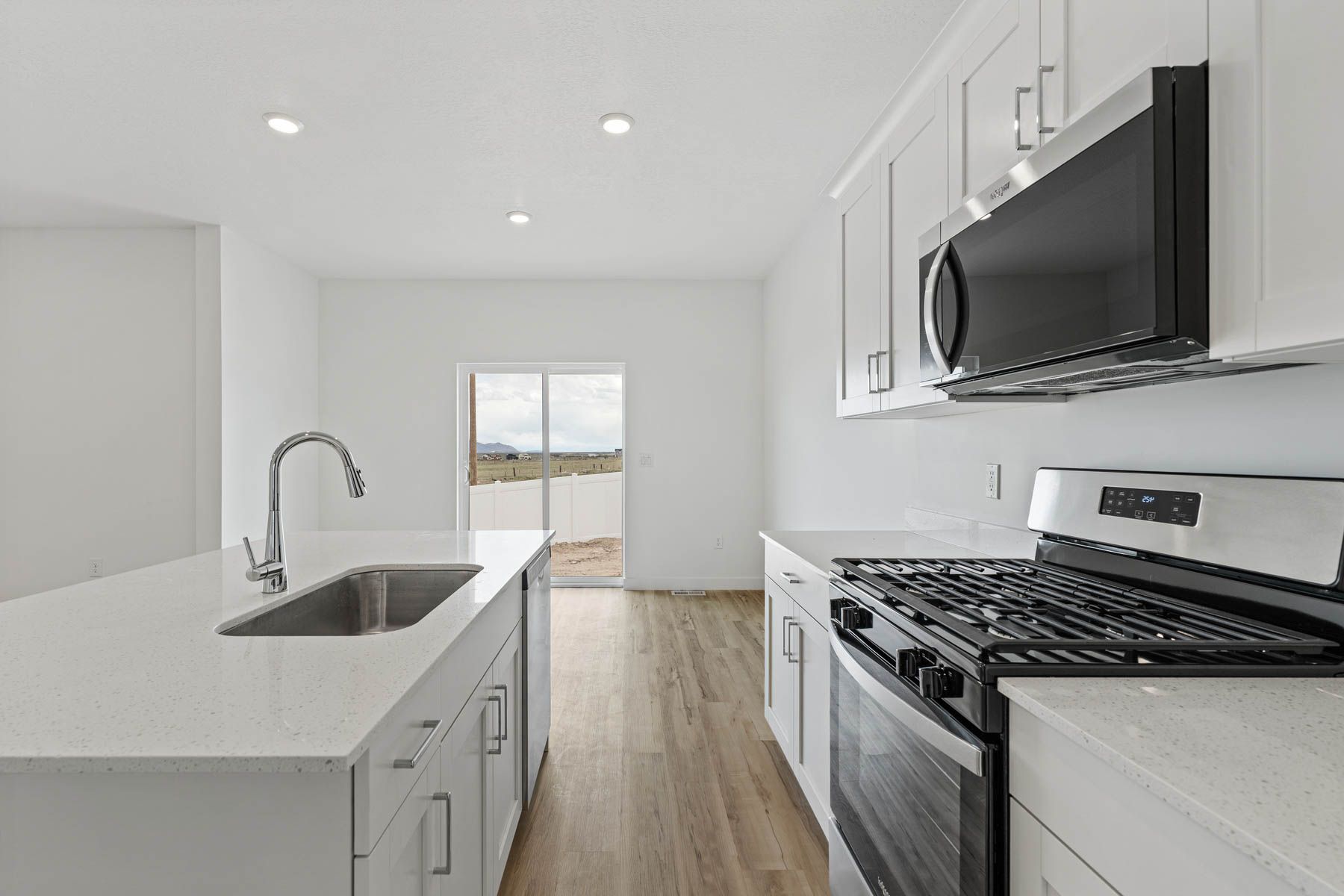 The kitchen has sprawling quartz countertops.
