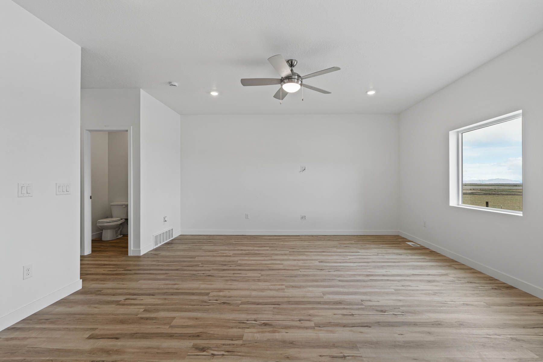 The powder room sits right off of the foyer near the family room. 