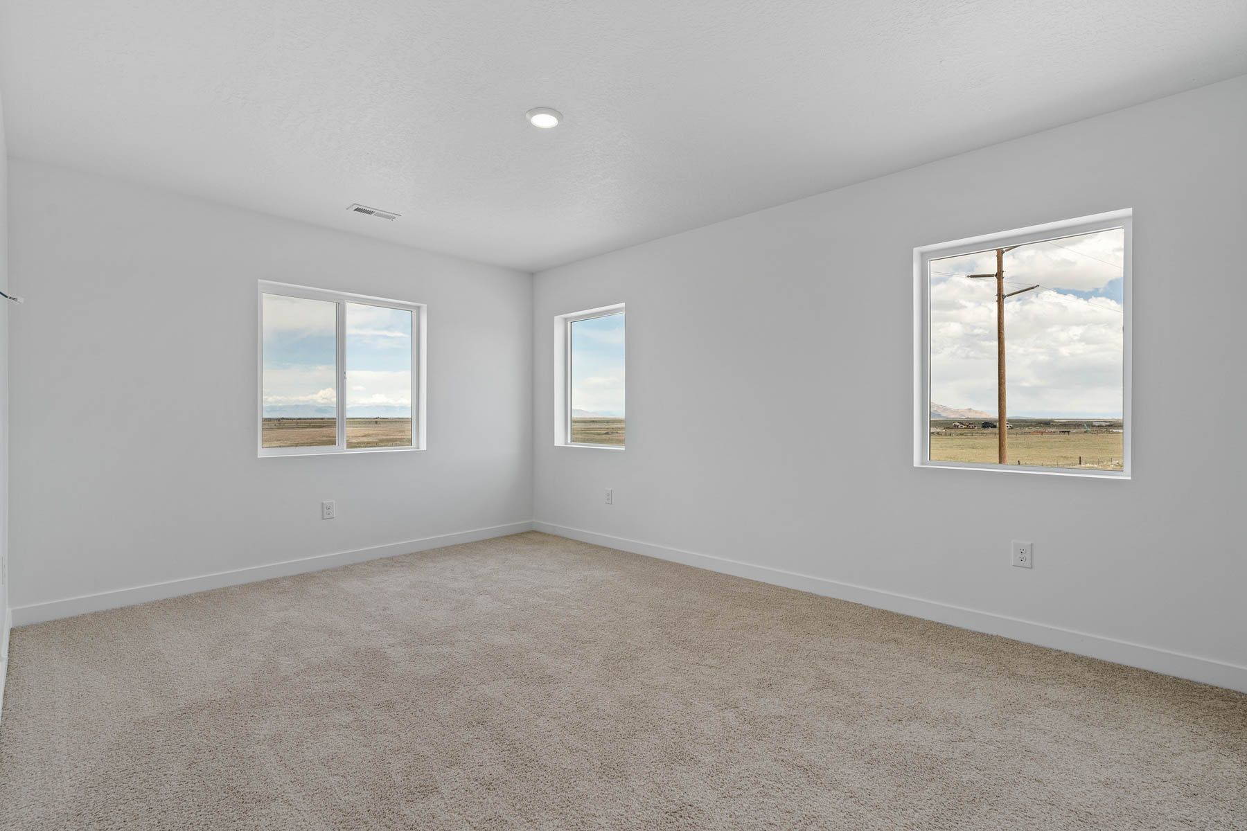 The master bedroom has a large window that lets in great, natural light. 