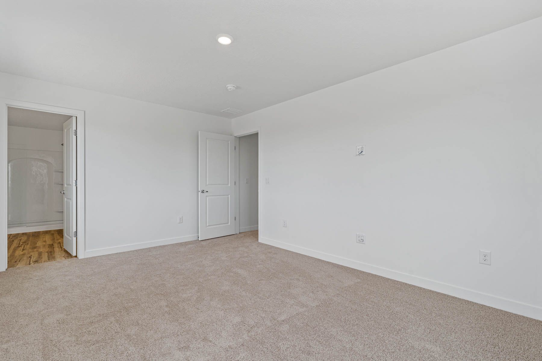 The master suite has a large bedroom, ensuite bathroom and a walk-in closet.