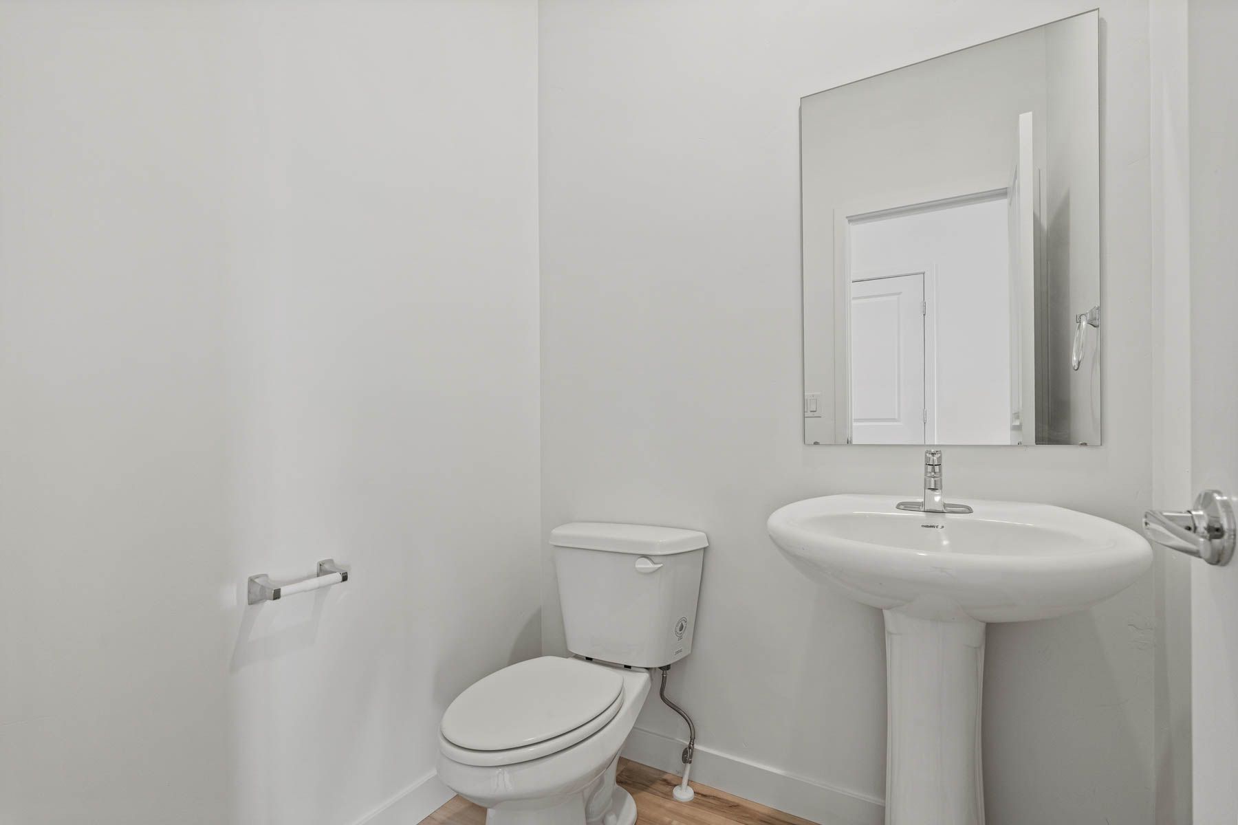Downstairs, the powder room sits right off of the foyer and family room.