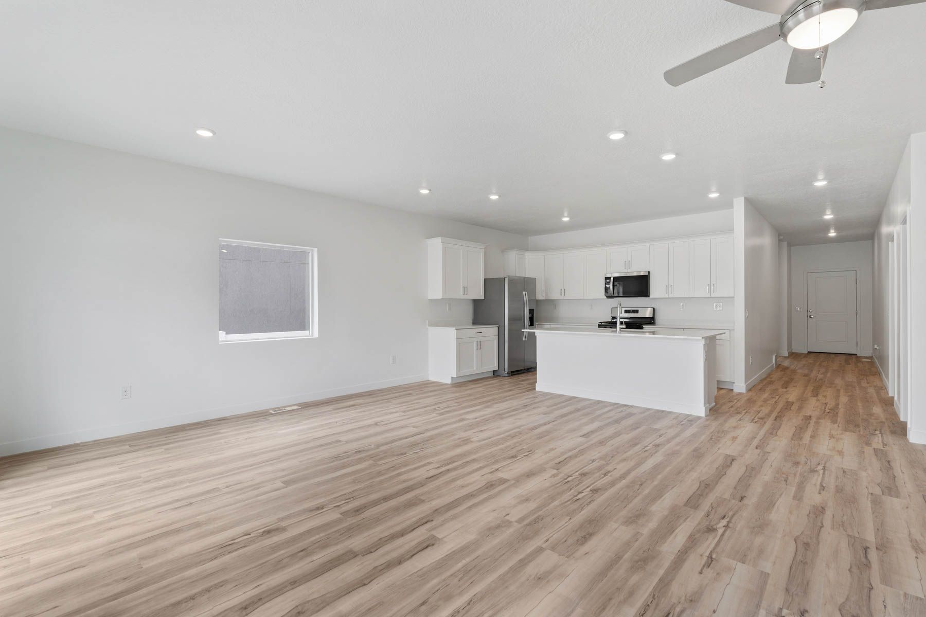 The open living spaces have beautiful vinyl plank flooring.