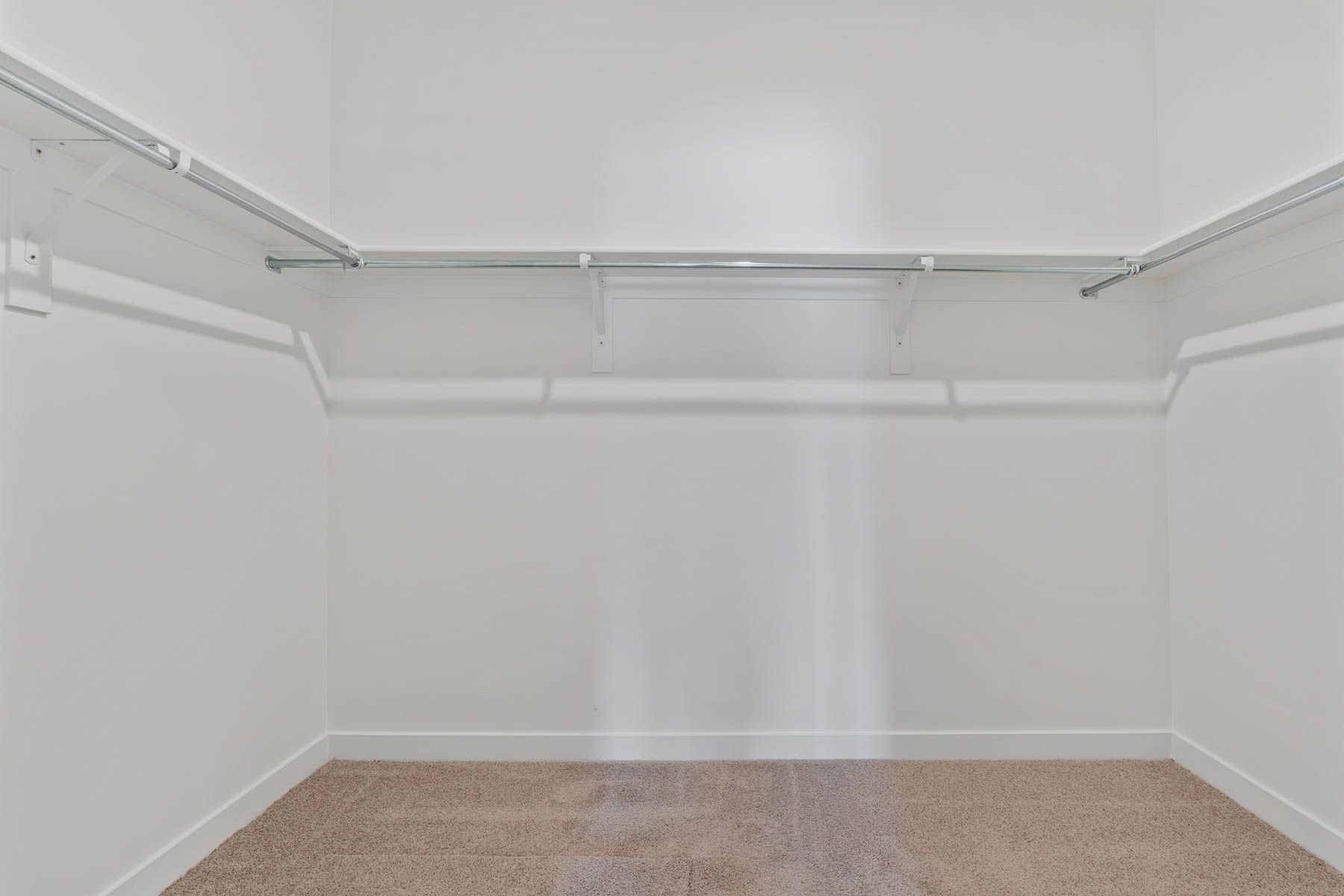 The walk-in closet has plenty of space for clothes, shoes and other personal belongings.