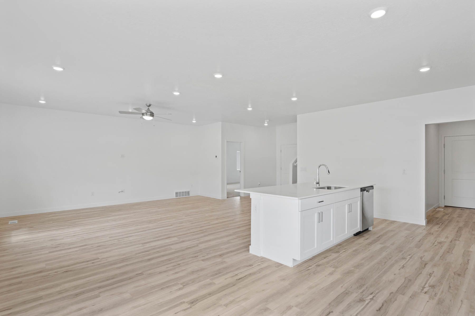 The kitchen has sprawling quartz countertops.