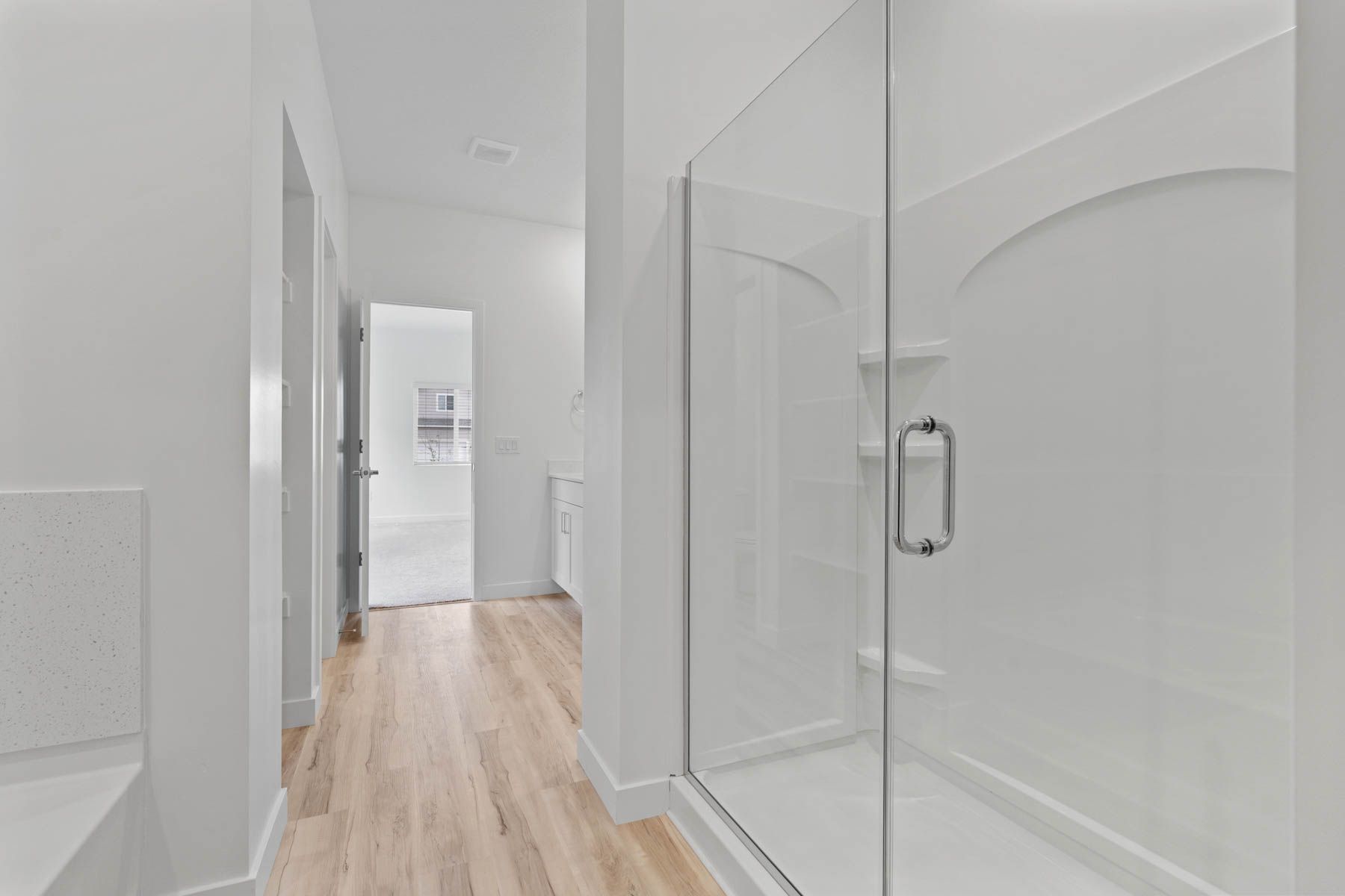 The master bathroom has a glass, walk-in shower and garden tub. 
