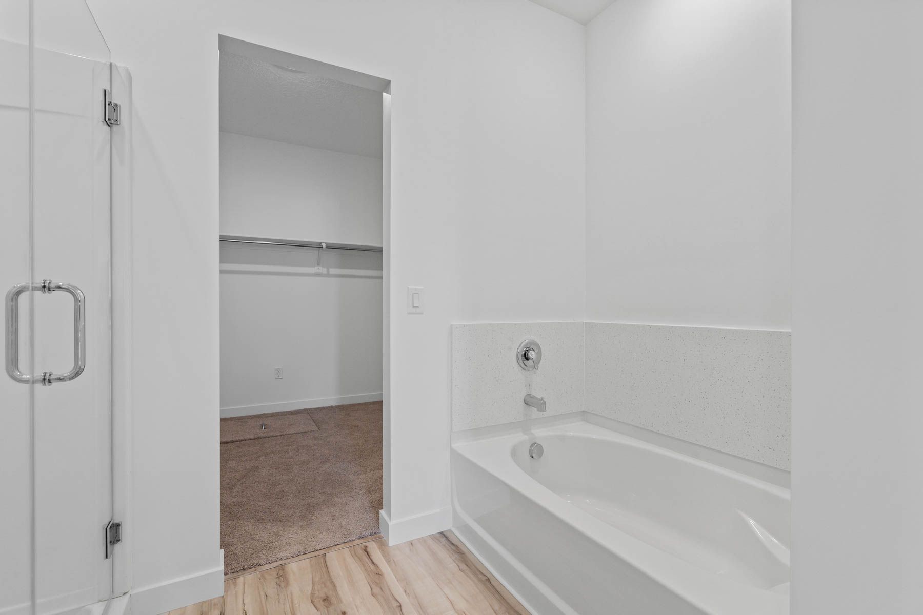 The master bathroom has a glass, walk-in shower and garden tub. 