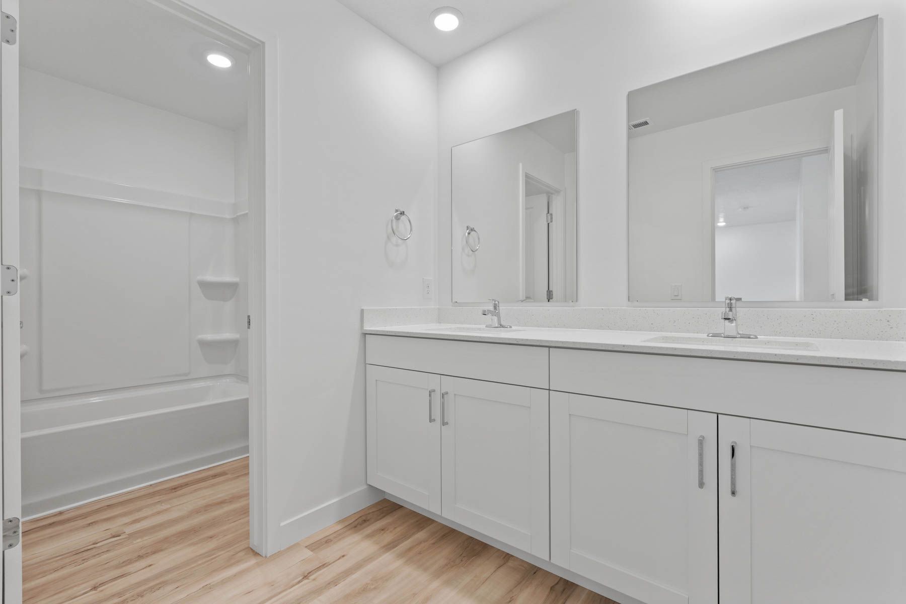 The secondary bathroom has a sprawling dual-sink vanity.