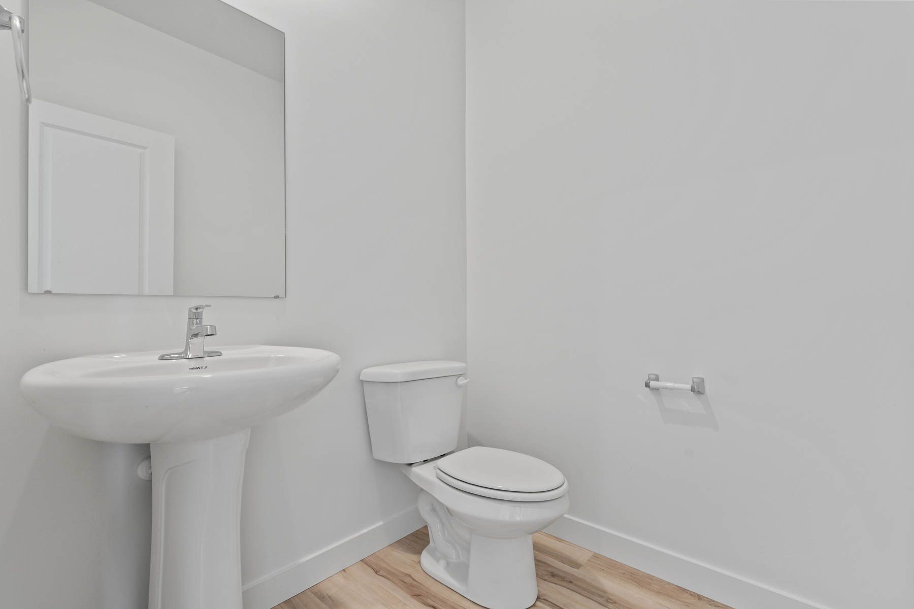 The powder room sits right off of the foyer.