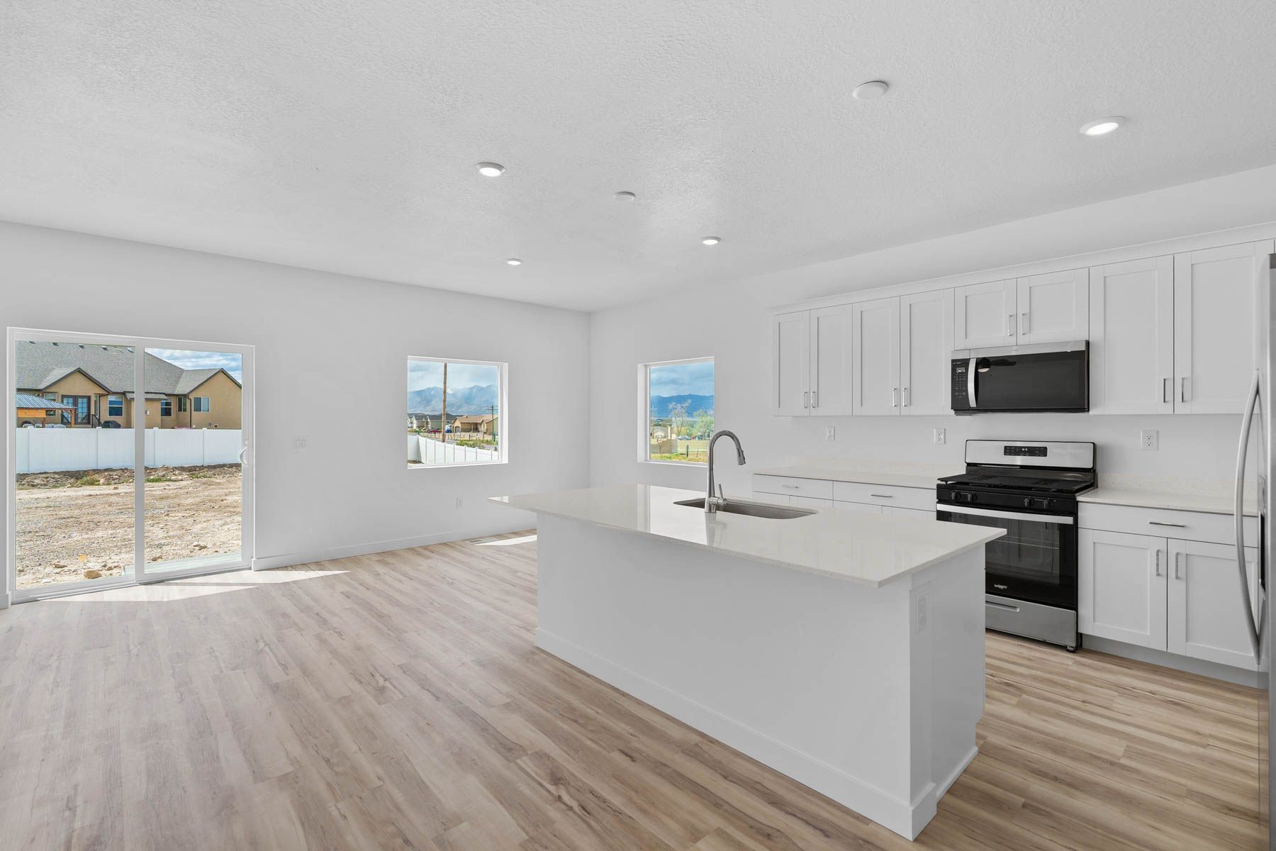 The kitchen has beautiful white cabinetry.