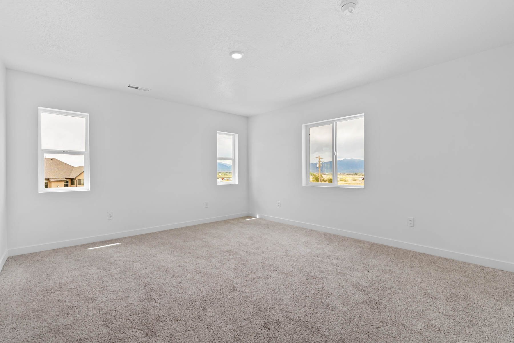 The master bedroom has a large window that lets in great, natural light. 