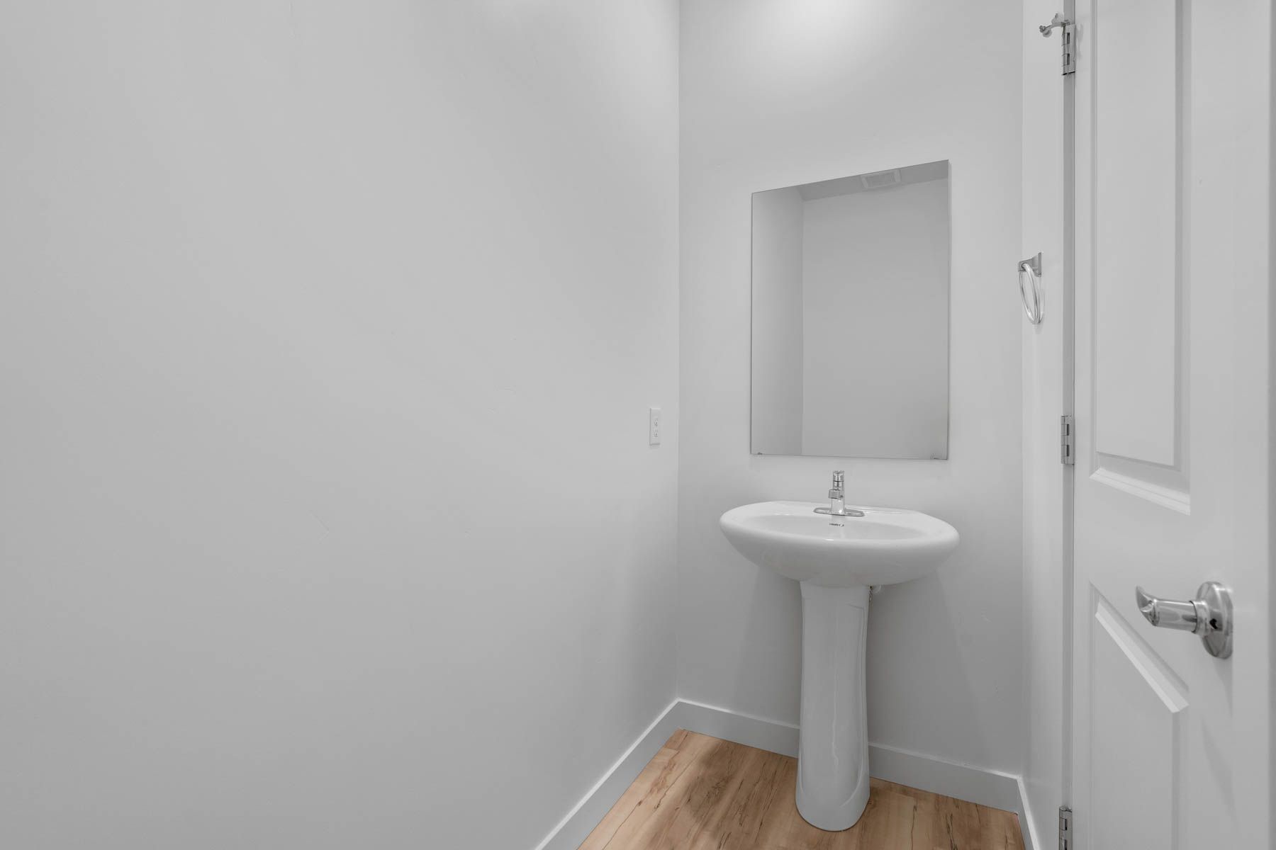 The powder room sits right off of the foyer.
