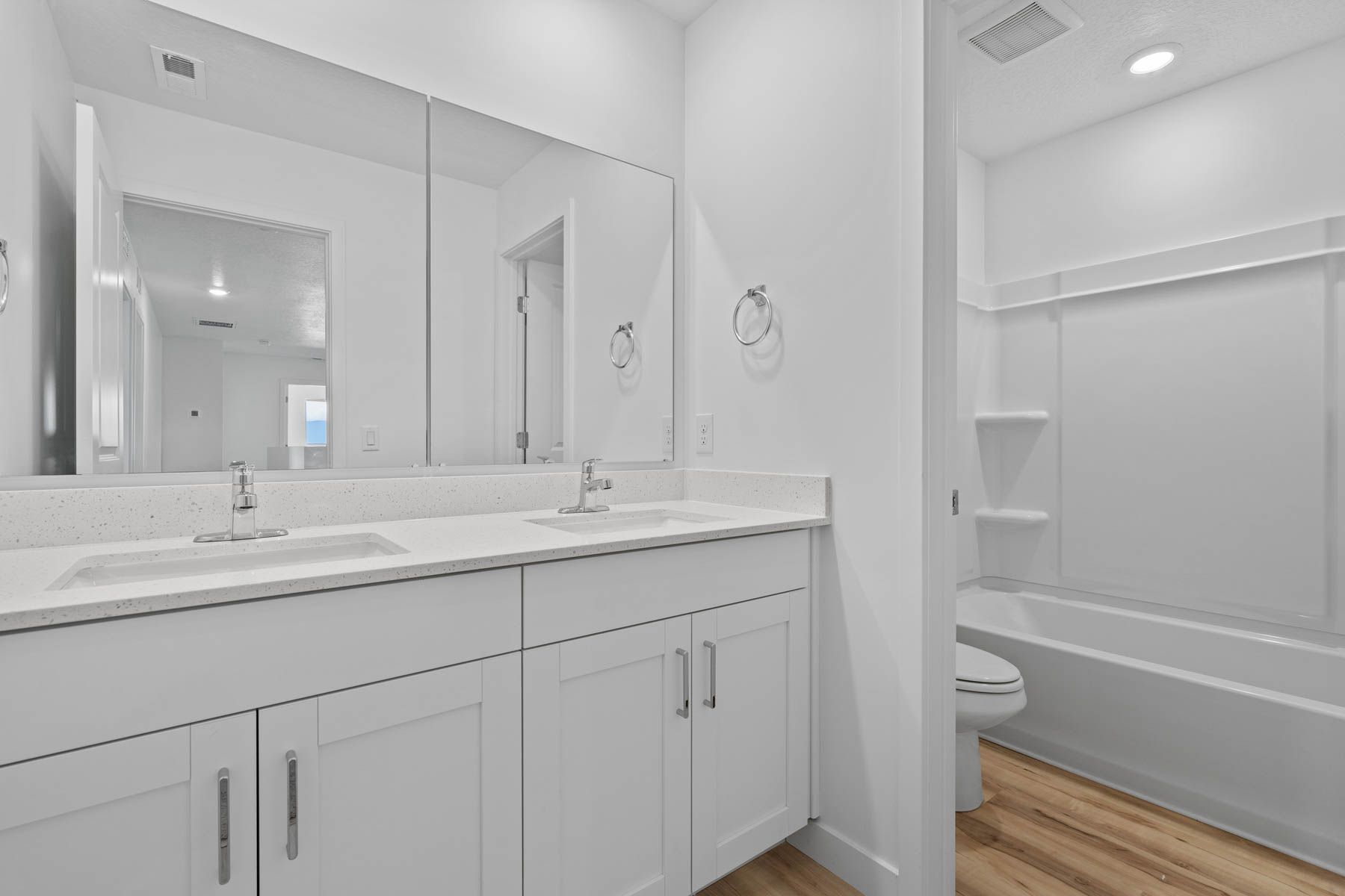 The secondary bathroom has a sprawling dual-sink vanity.