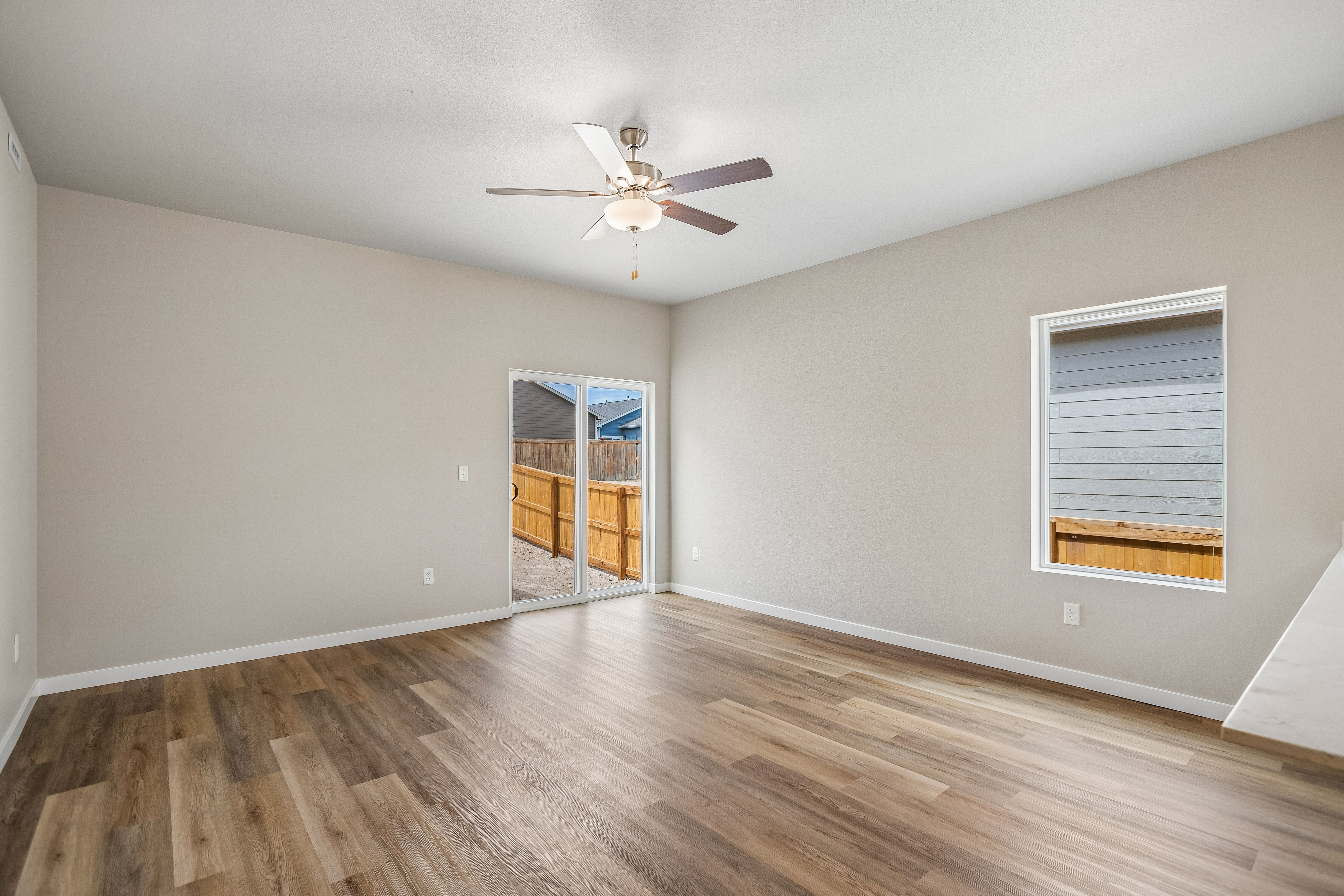 The family room is spacious with a ceiling fan.