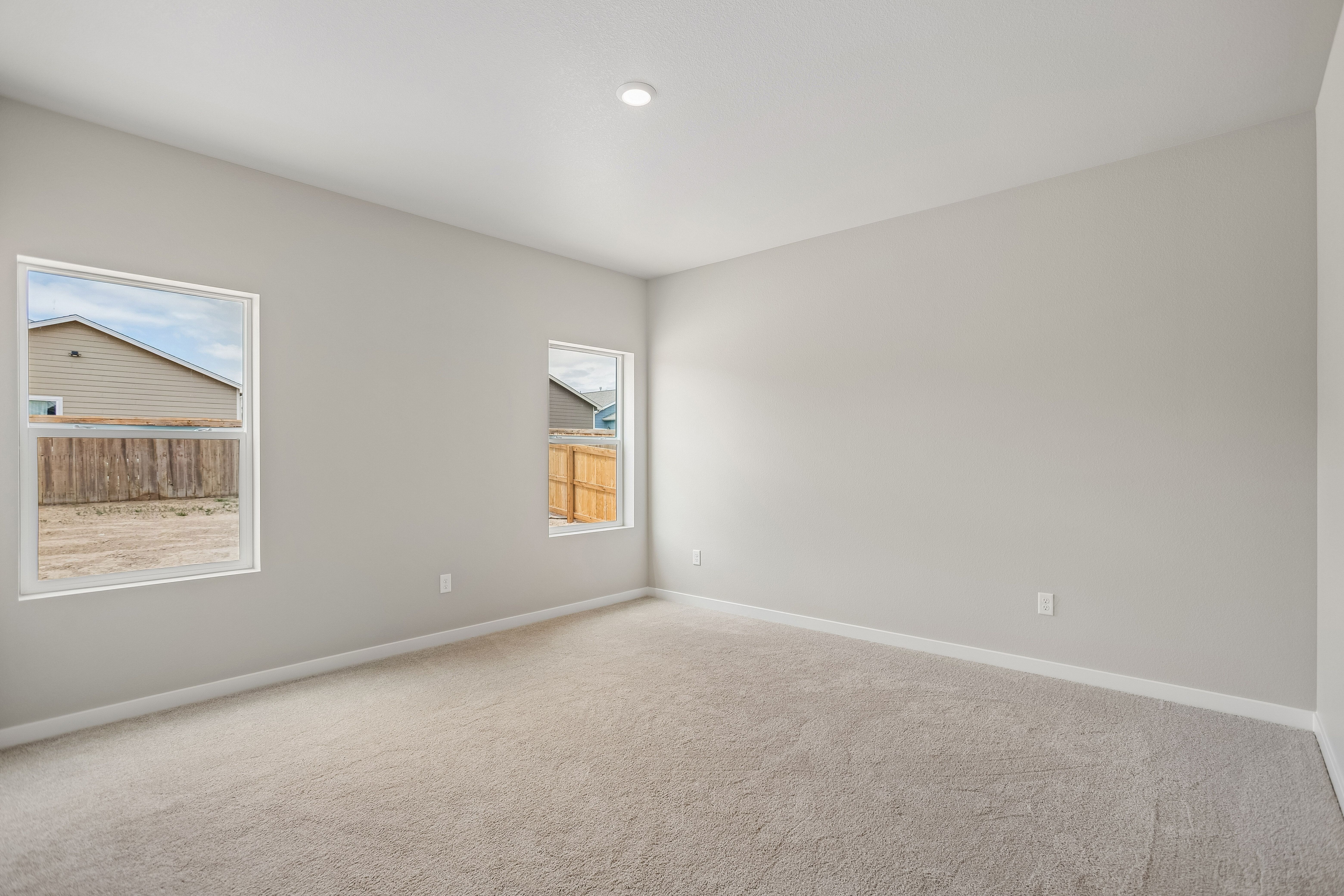 The master bedroom is spacious with large windows.