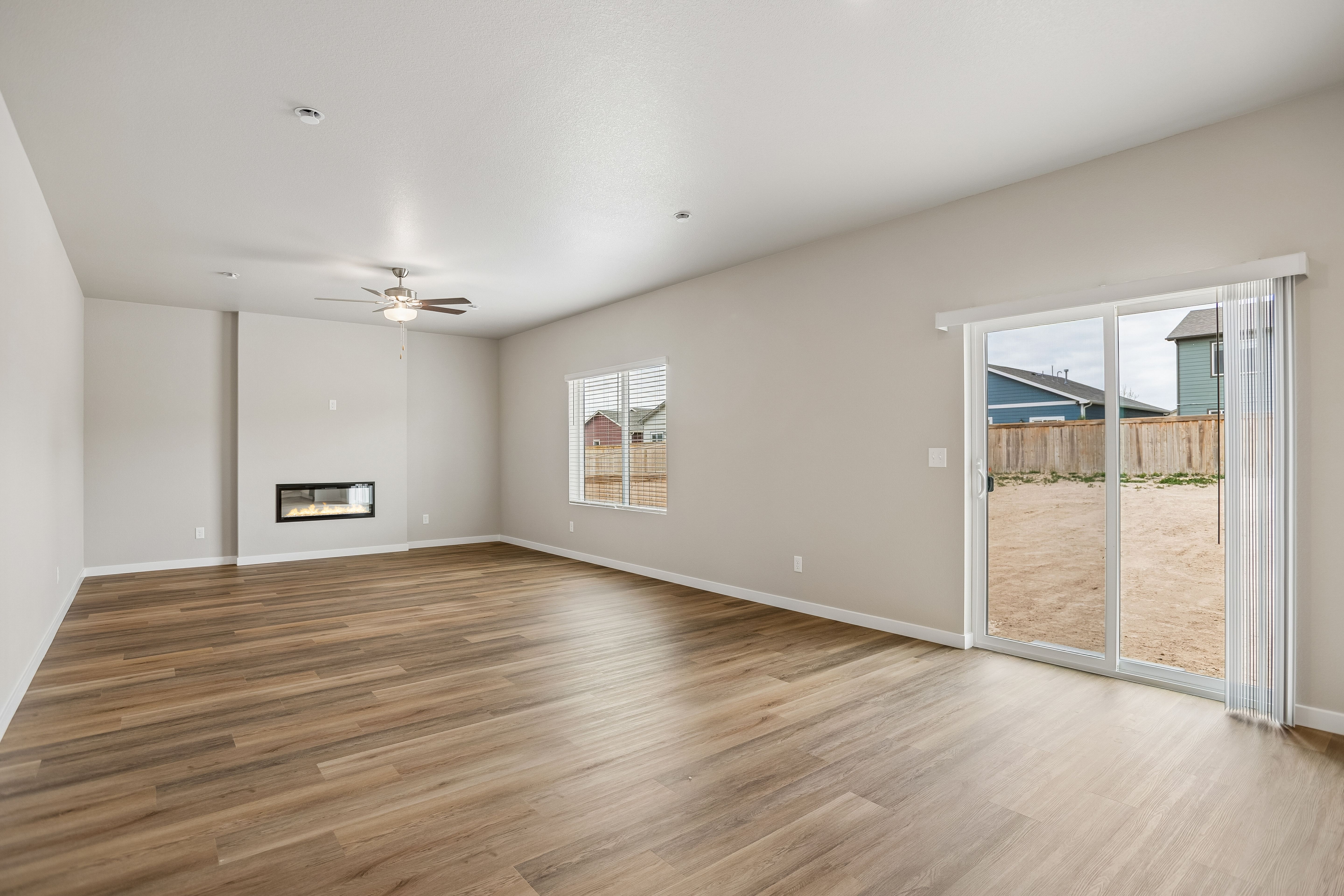 The family room is spacious with a ceiling fan.