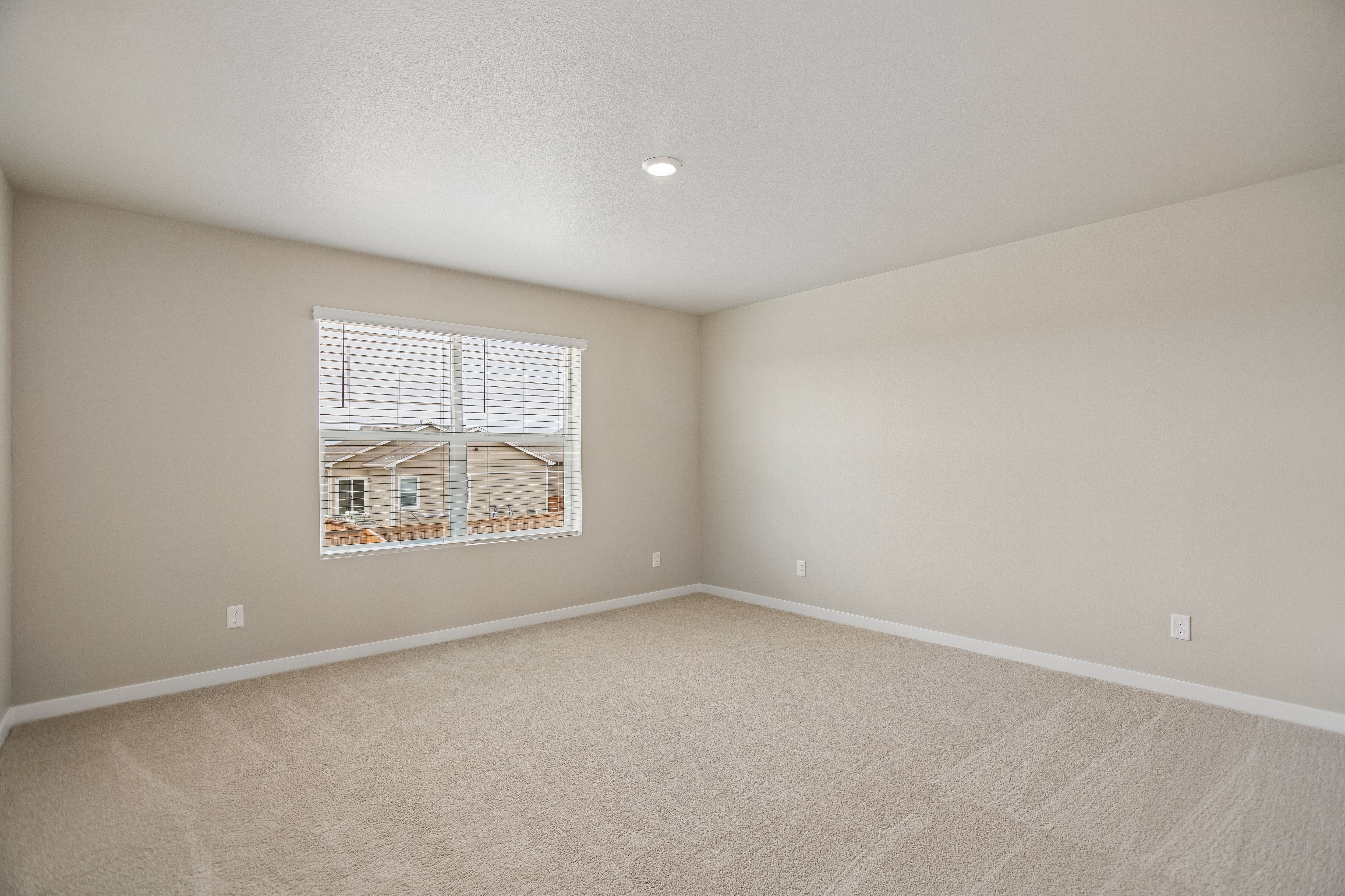 The master bedroom is spacious with large windows