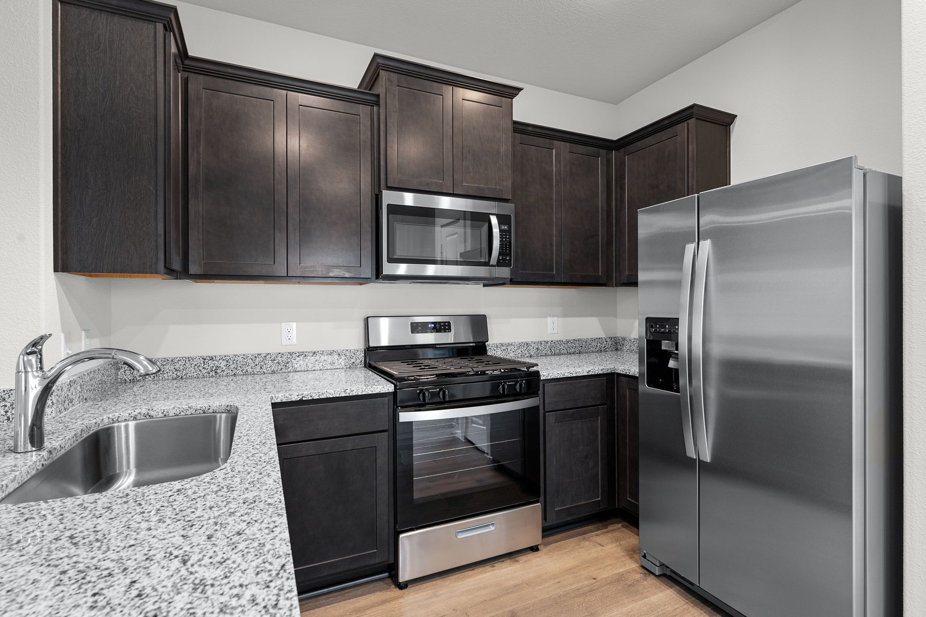 The kitchen has beautiful wood cabinetry.