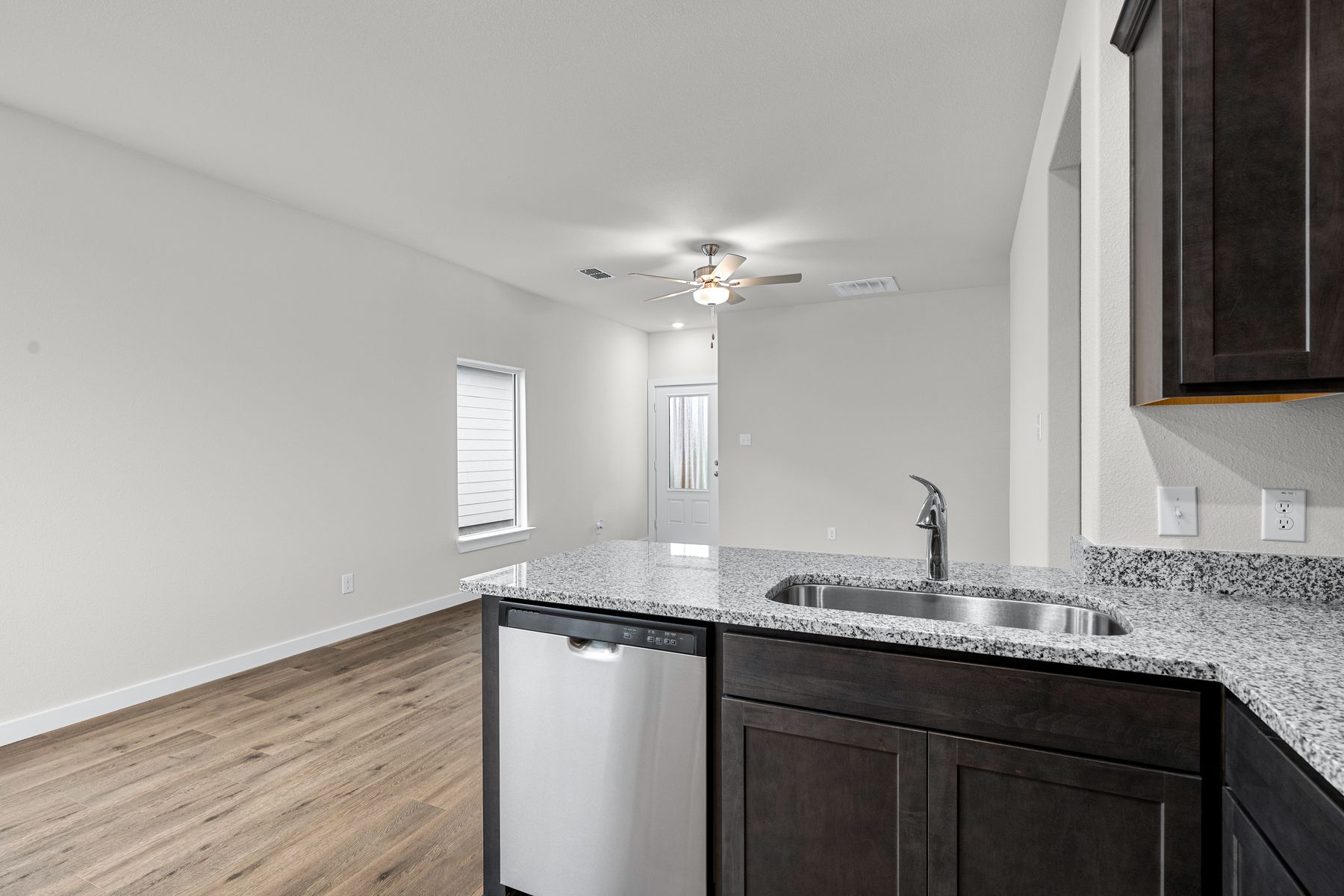 The kitchen looks out into the family room.