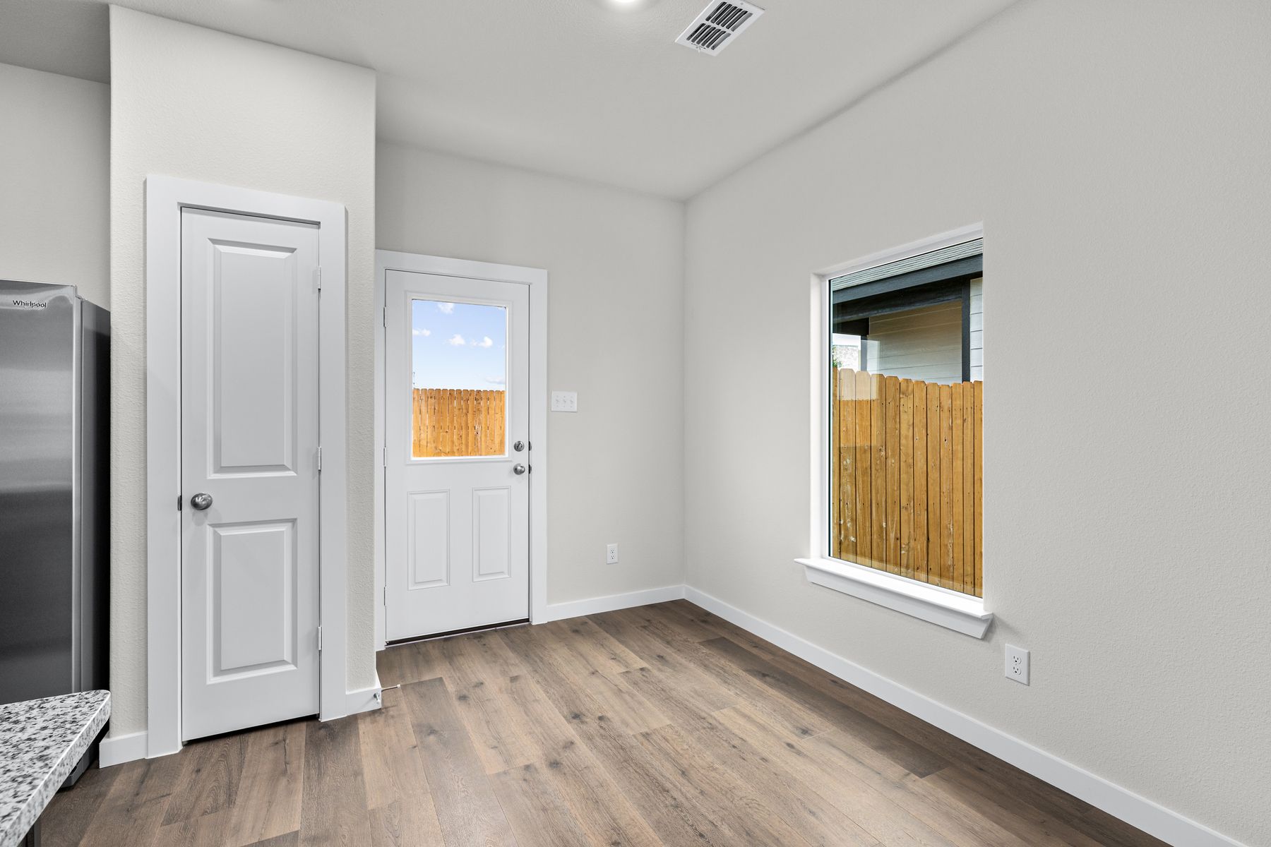 The dining room has a large window that lets in natural light.