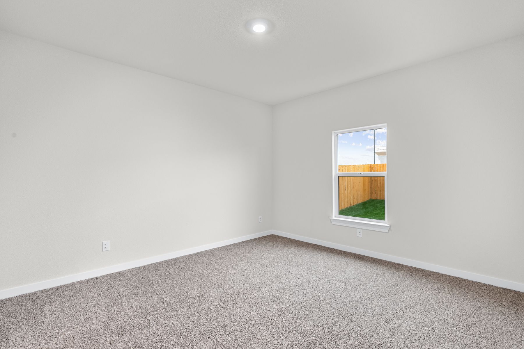 The master bedroom is spacious and has a large window.