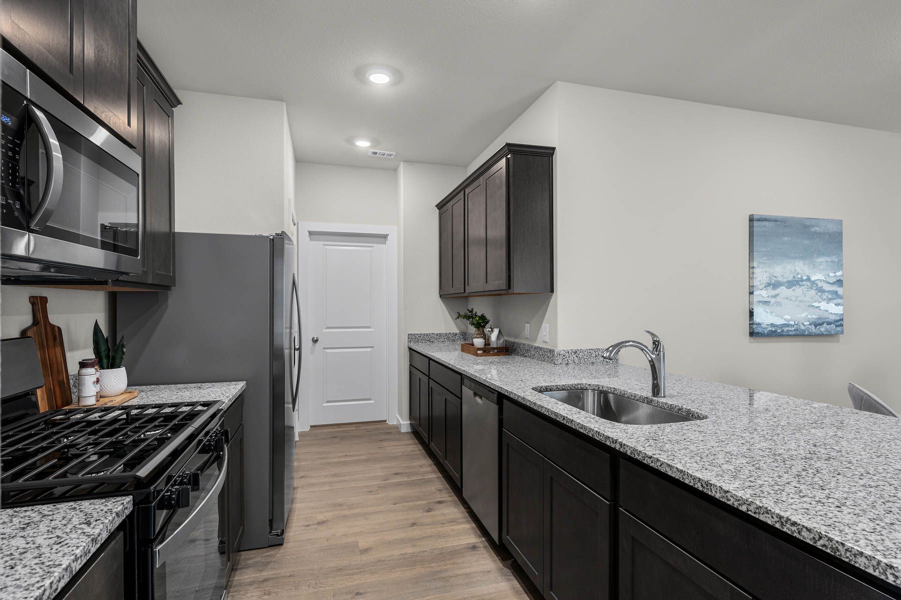 The kitchen has plenty of cabinet space for storage. 