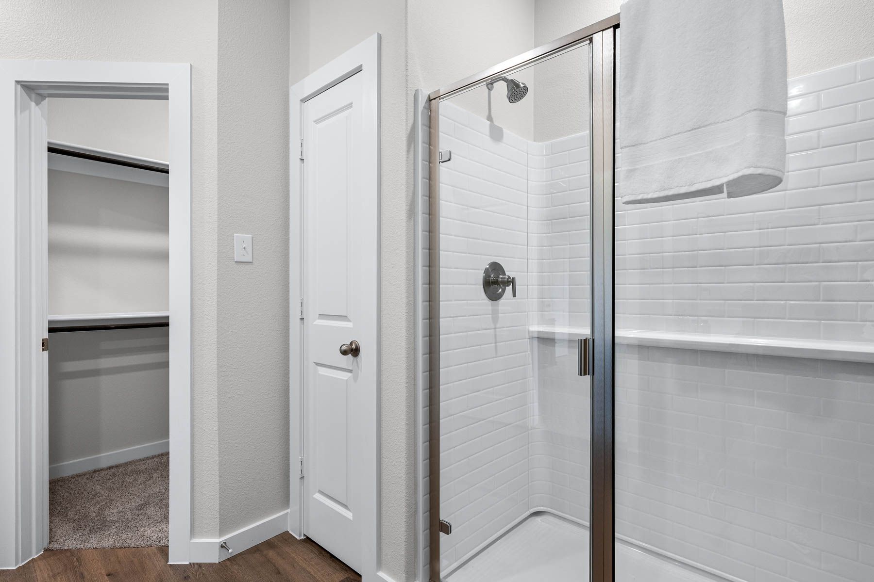 The master bathroom has a walk-in, glass shower.