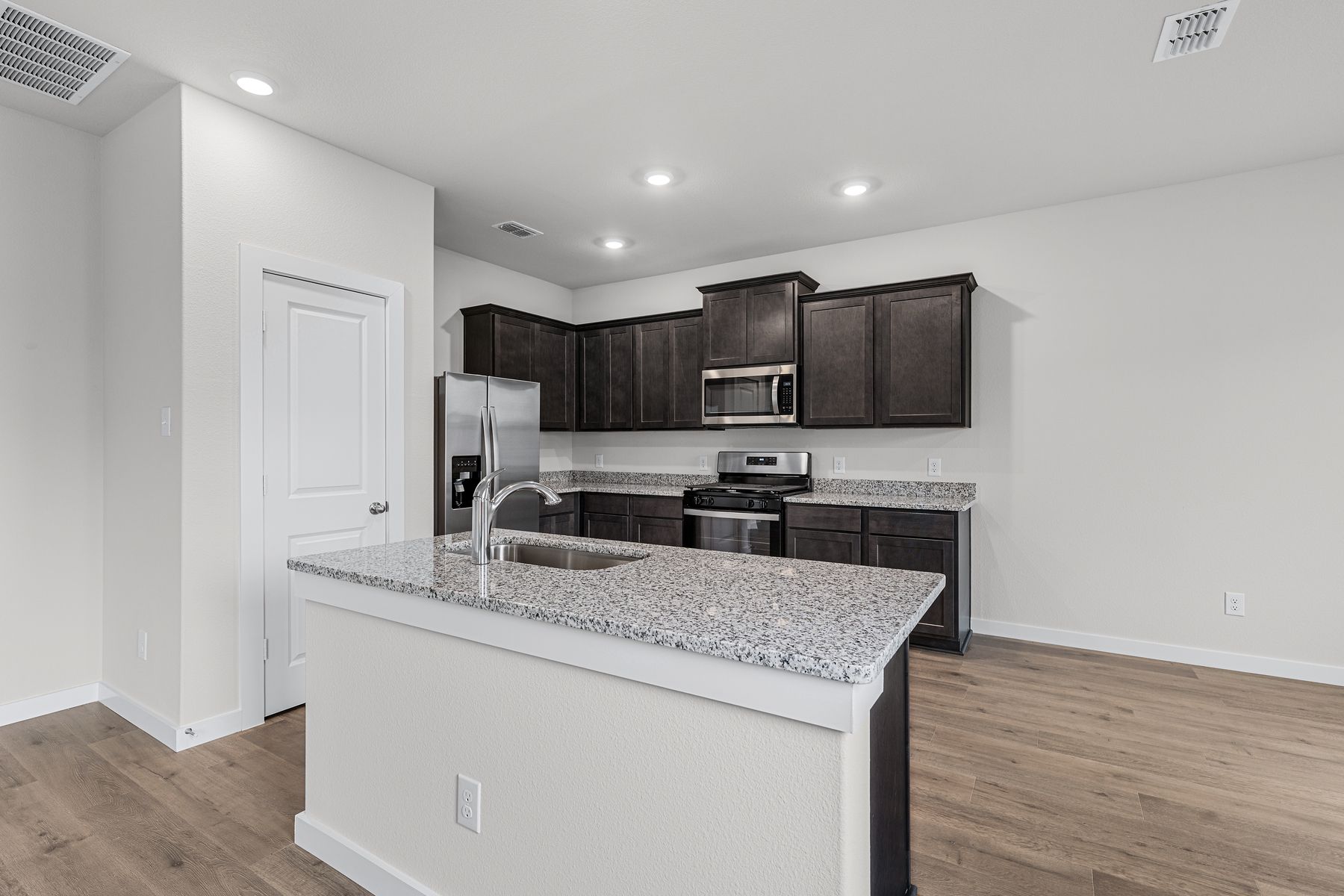 The kitchen has beautiful wood cabinetry.