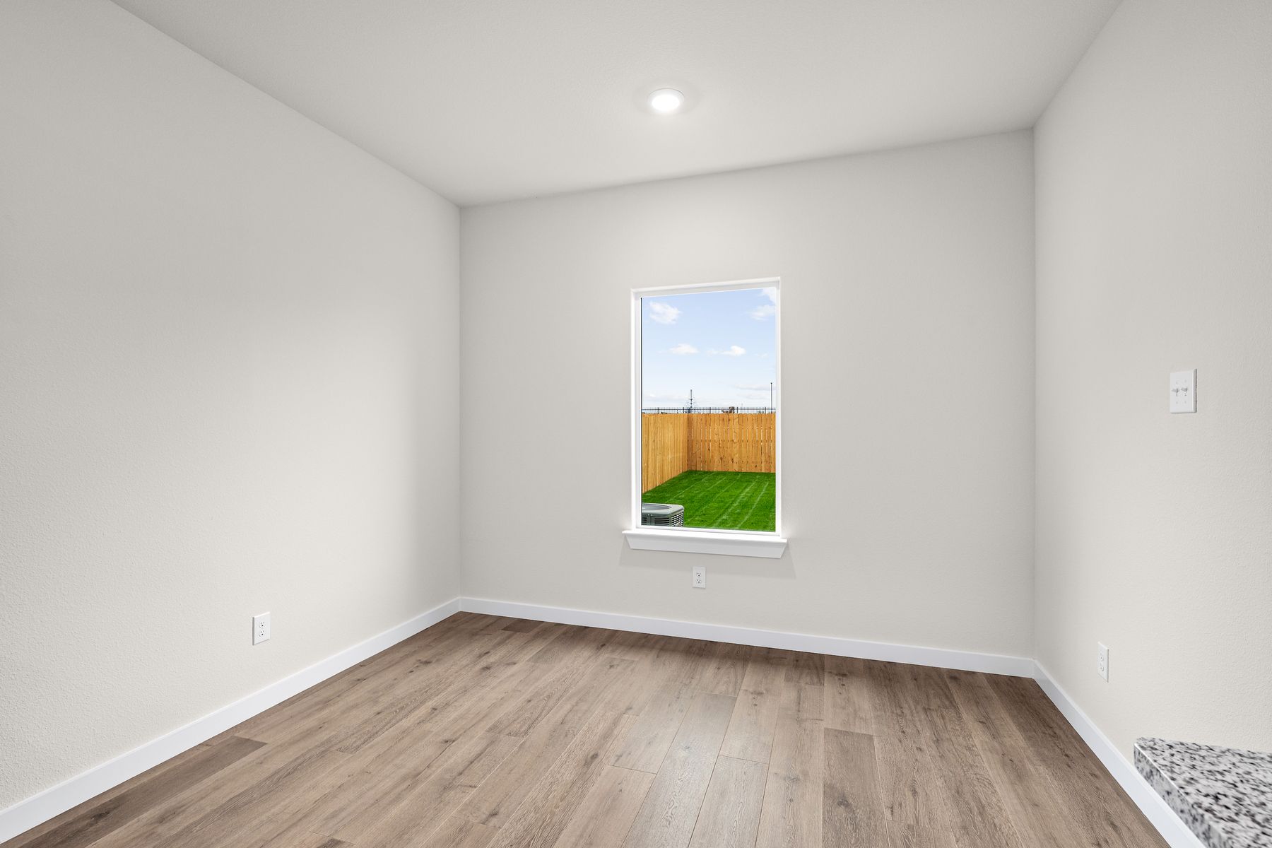 The dining room has a large window that lets in great, natural light. 