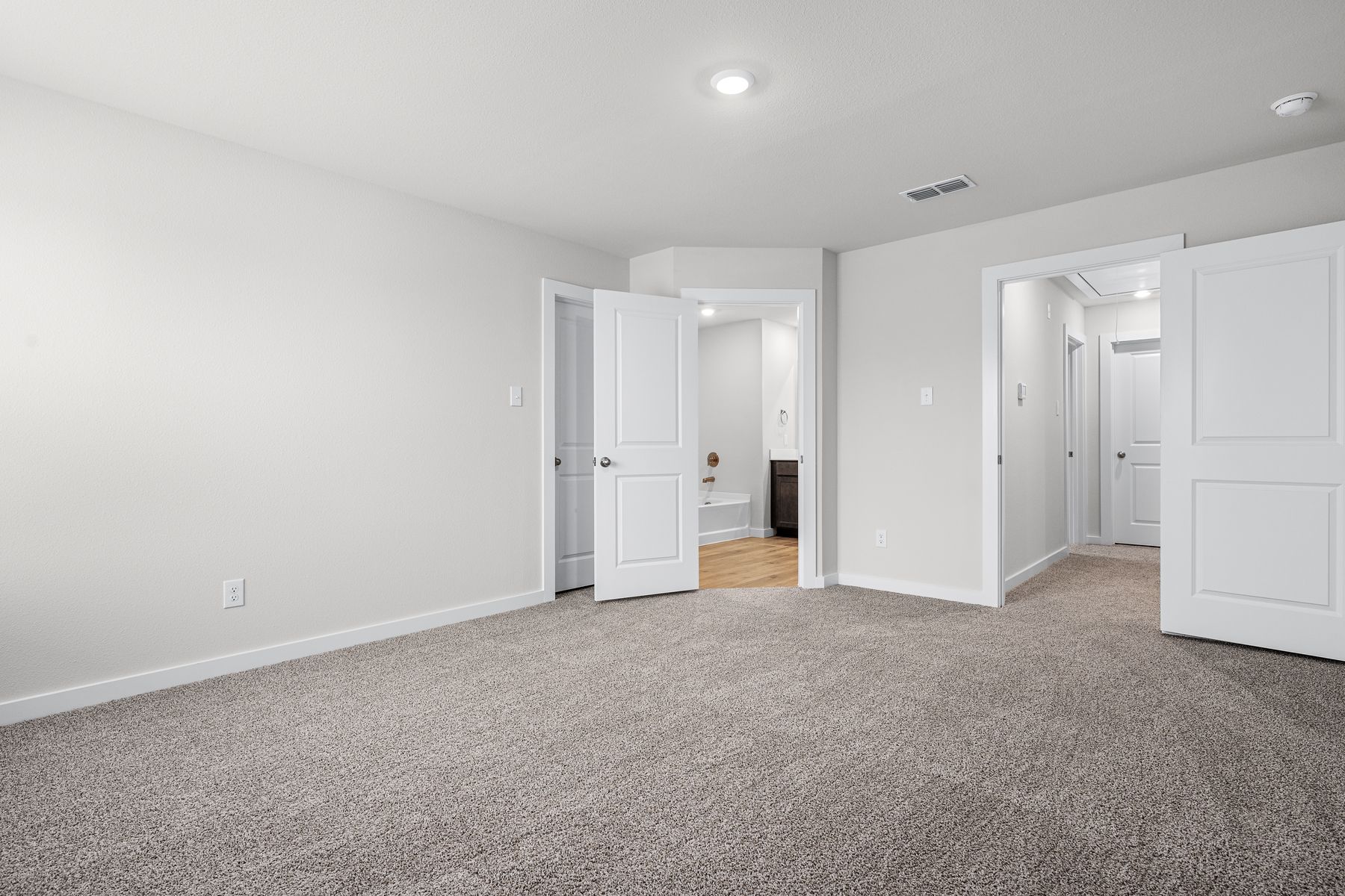 The master suite has a large bedroom, ensuite bathroom and a walk-in closet. 