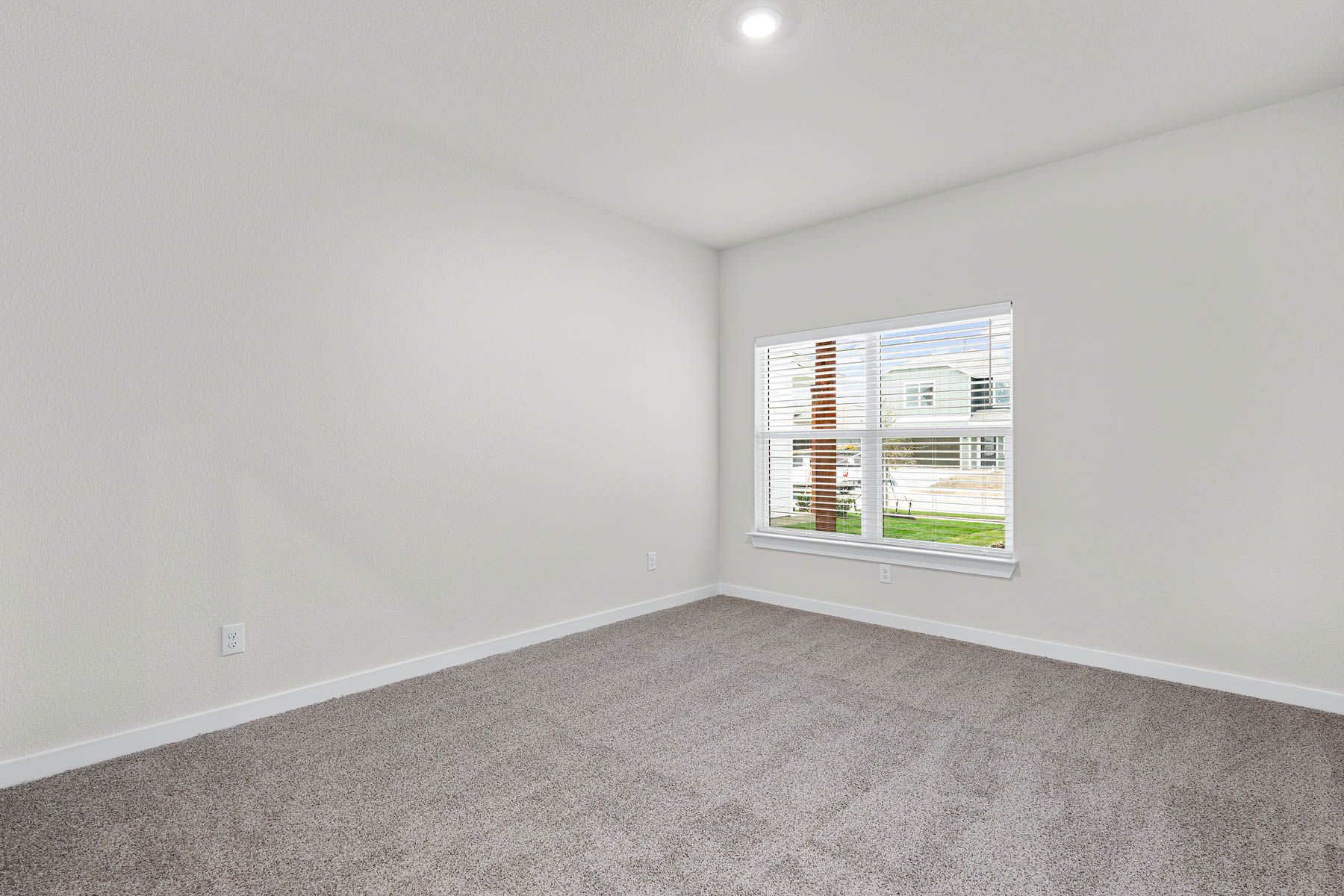 The master bedroom is spacious and has a large window.