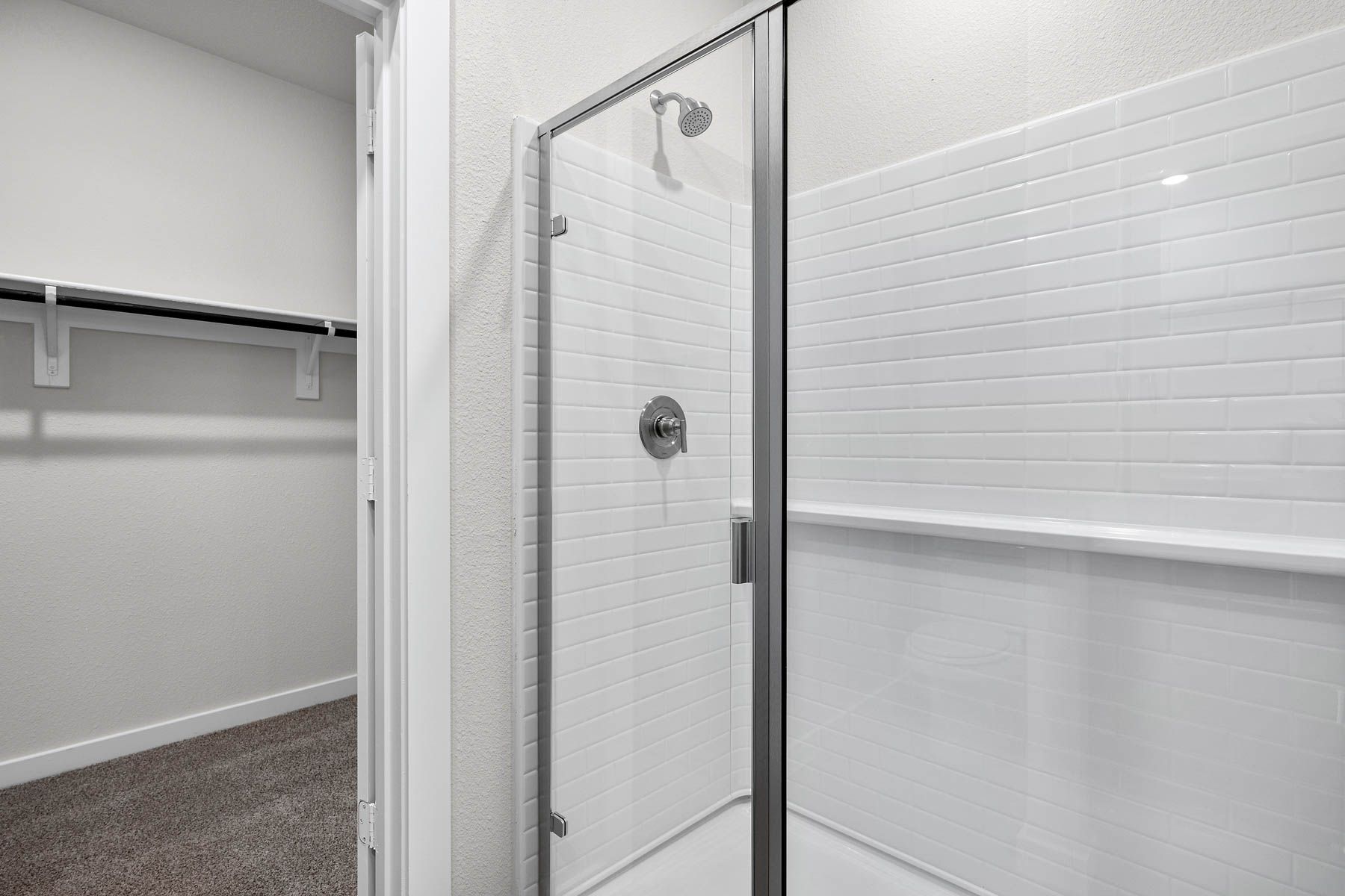 The master bathroom has a glass, walk-in shower.