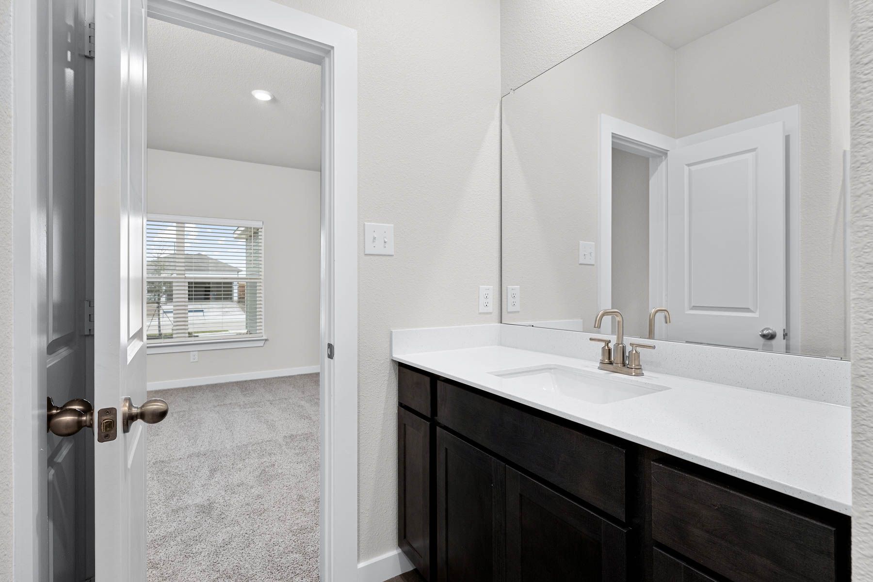 The master bathroom has a sprawling vanity.