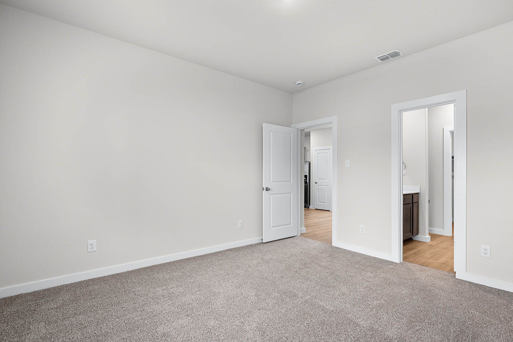 The master suite has a large bedroom, ensuite bathroom and a walk-in closet. 